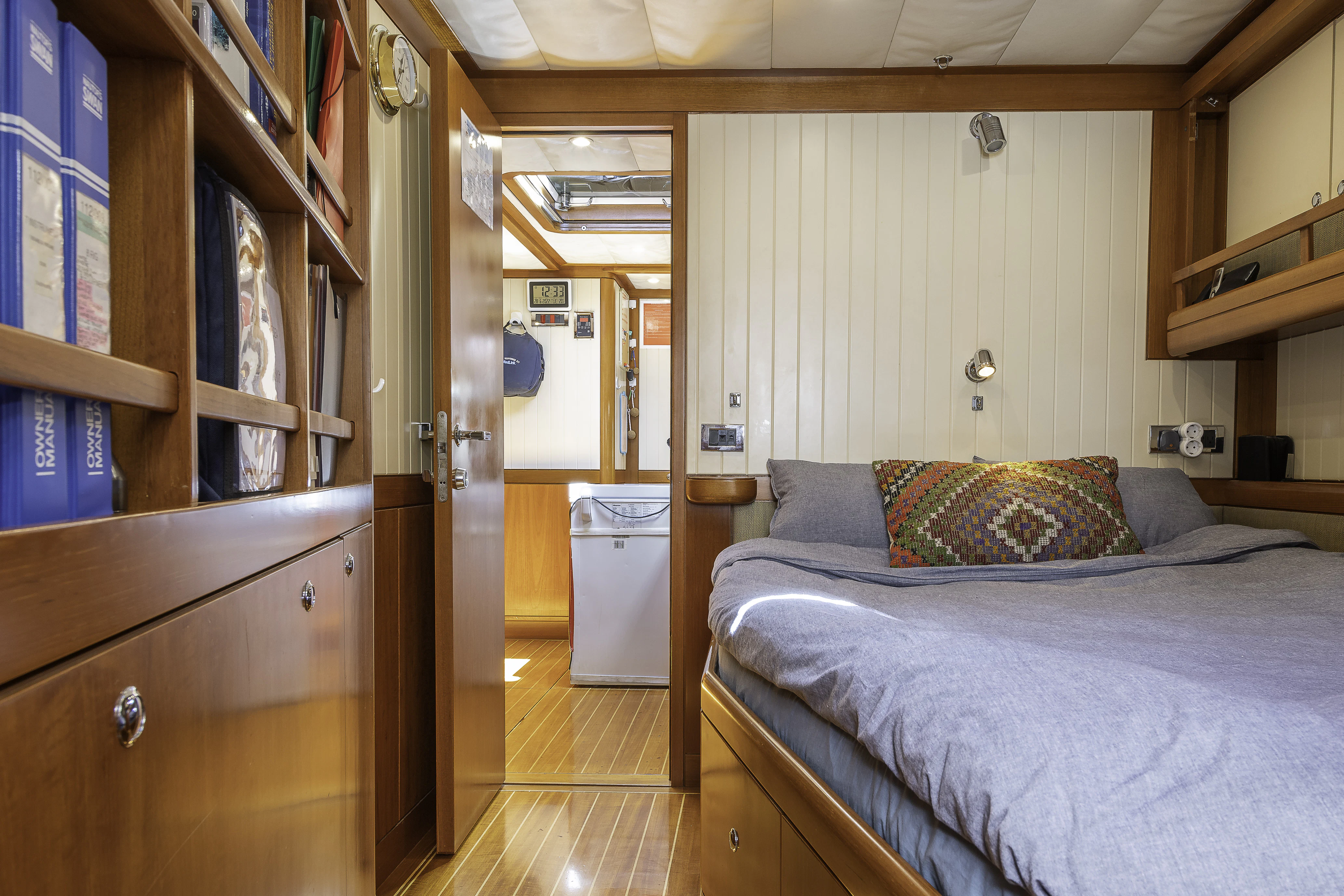 a bedroom with a bed and a closet aboard SONG OF THE SEA Yacht for Sale