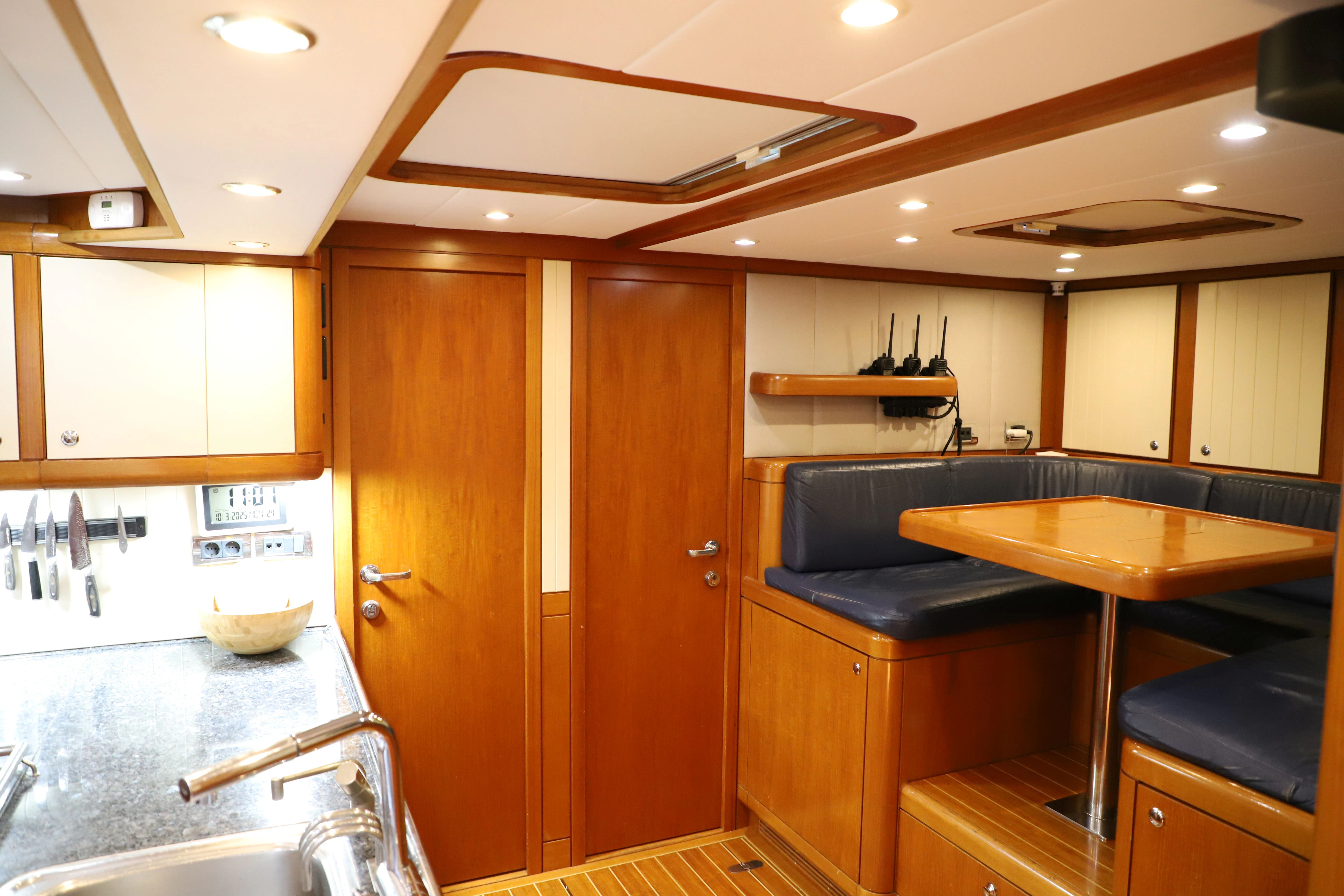 a kitchen with wooden cabinets aboard SONG OF THE SEA Yacht for Sale