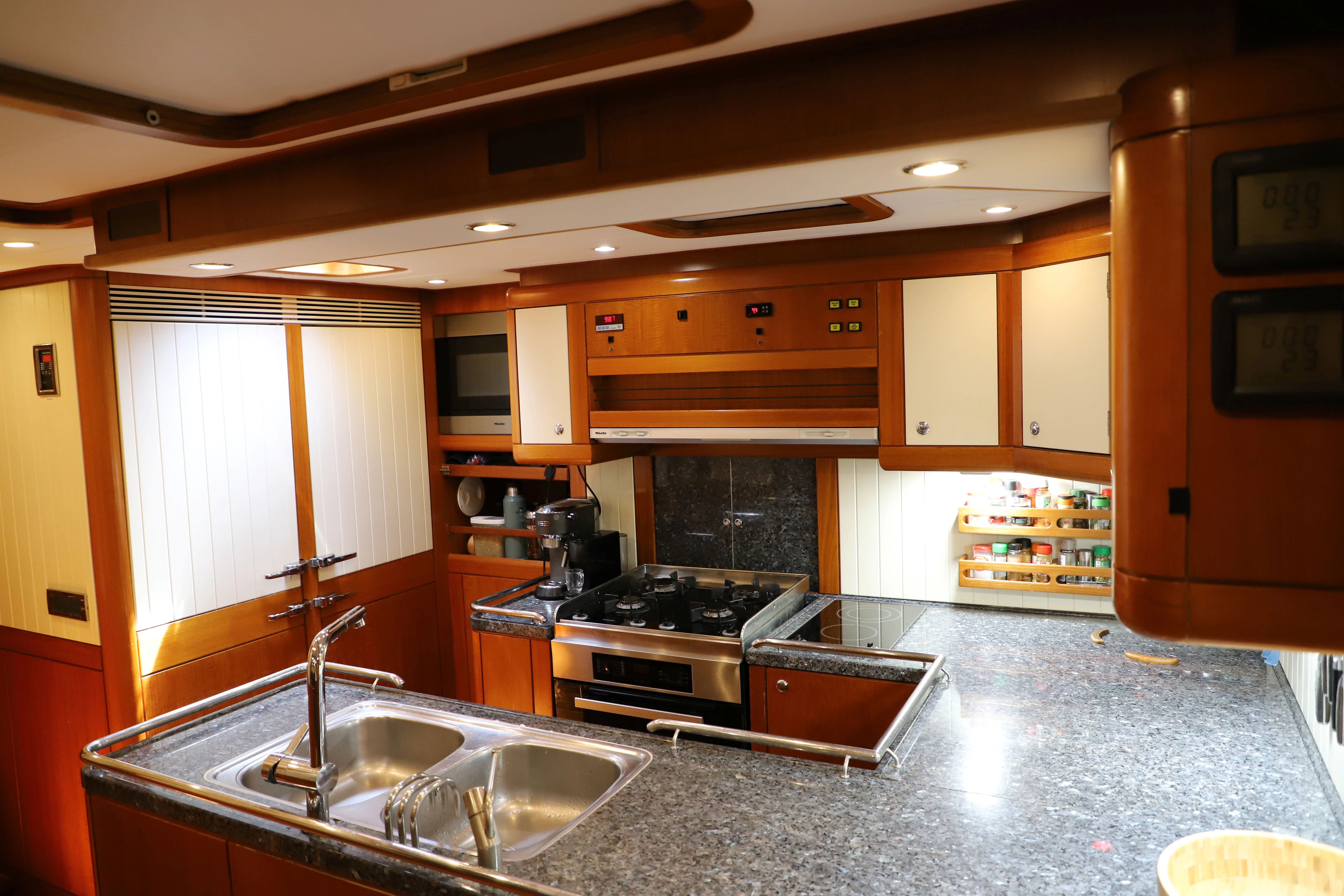 a kitchen with a stove and sink aboard SONG OF THE SEA Yacht for Sale