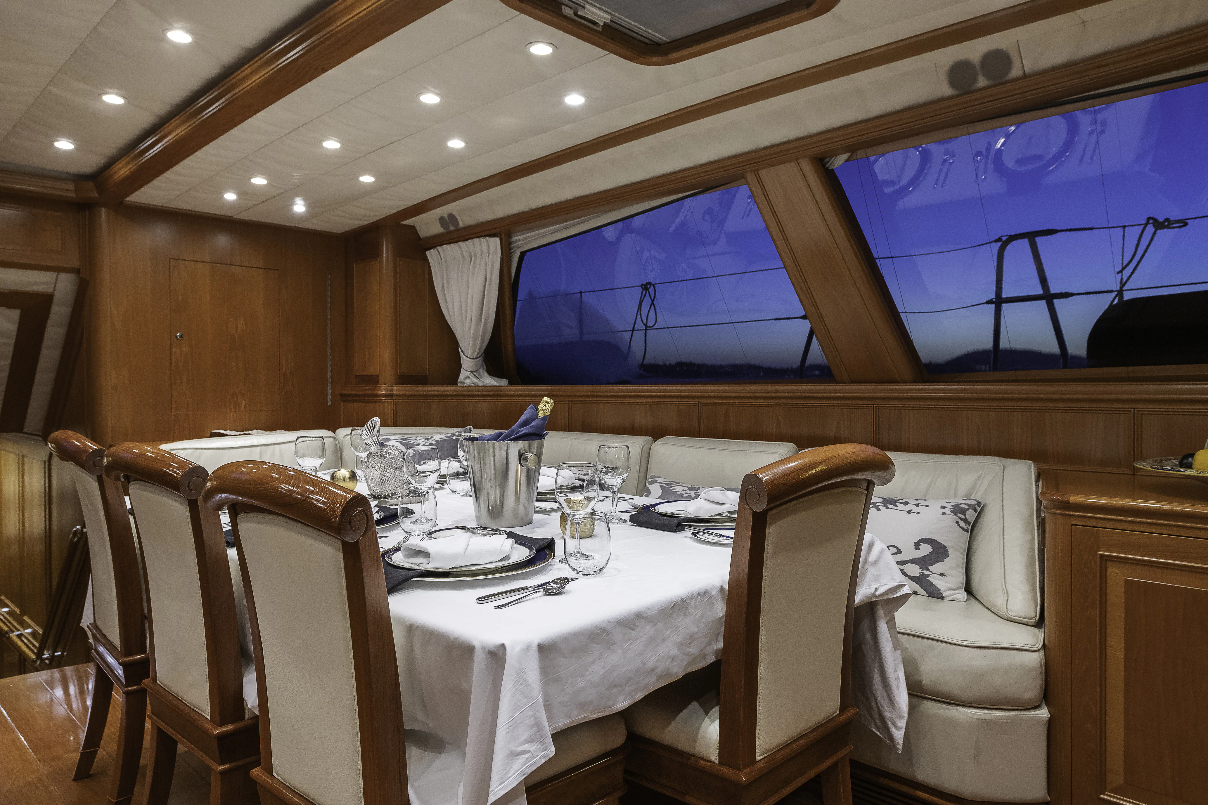 a room with a table and chairs aboard SONG OF THE SEA Yacht for Sale