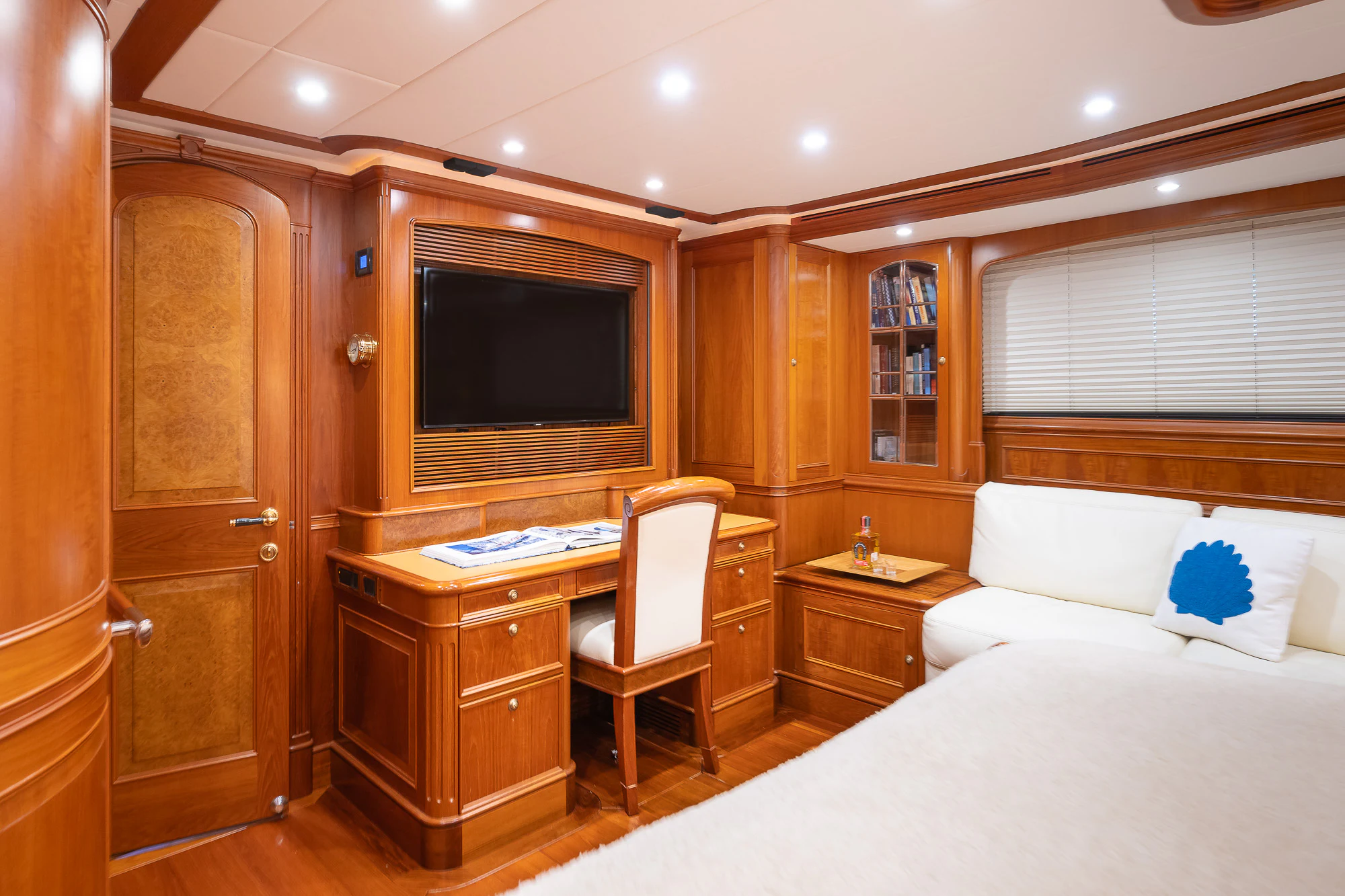 a bedroom with a bed and a desk aboard SONG OF THE SEA Yacht for Sale