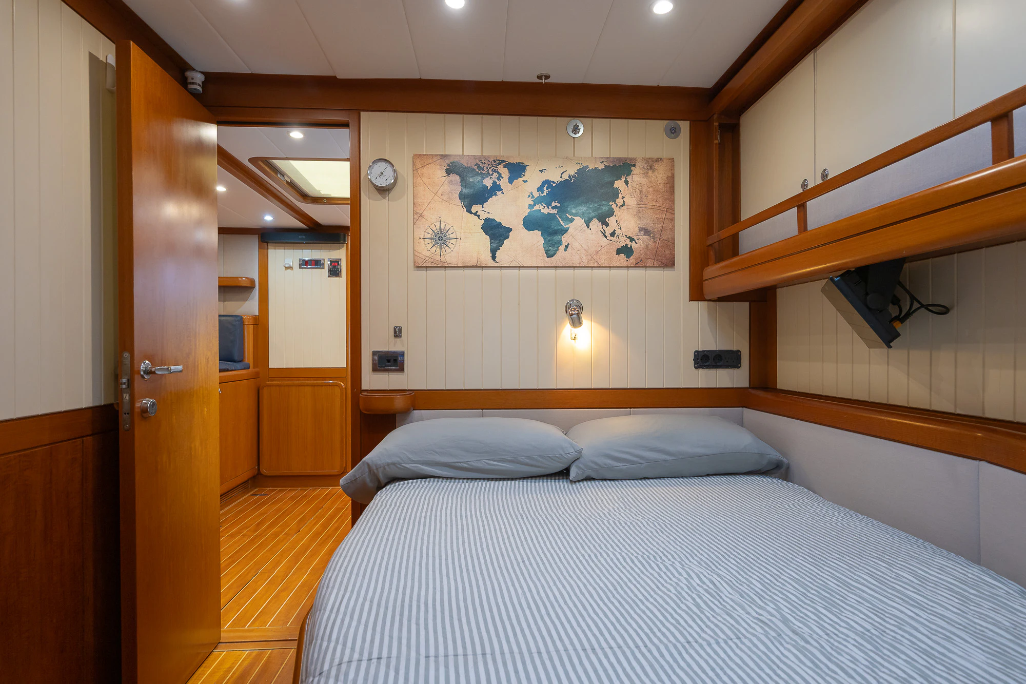 a bedroom with a bed and a door aboard SONG OF THE SEA Yacht for Sale