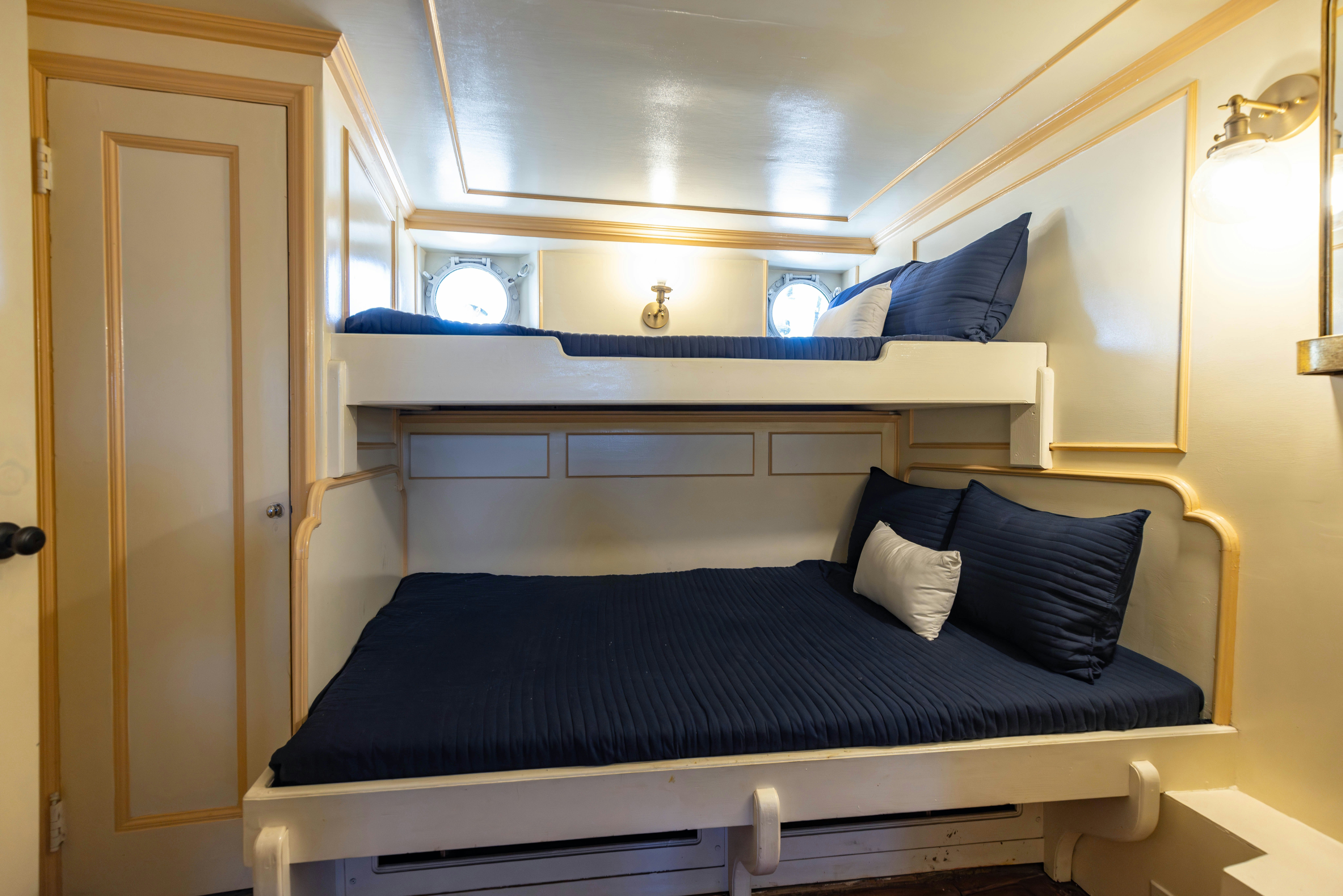 a bed with blue sheets aboard NORTHWIND Yacht for Sale