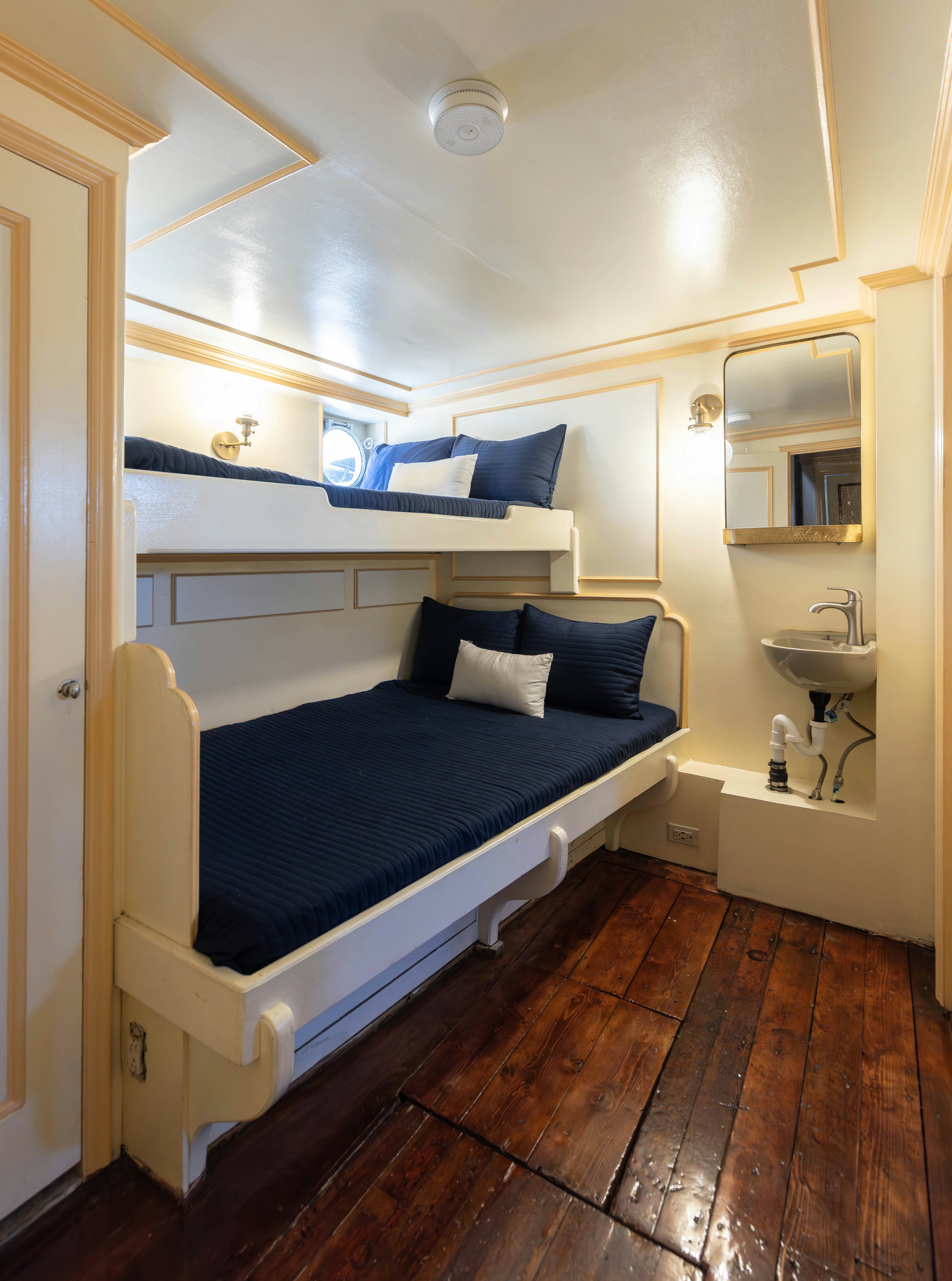 a bed with a blue sheet aboard NORTHWIND Yacht for Sale