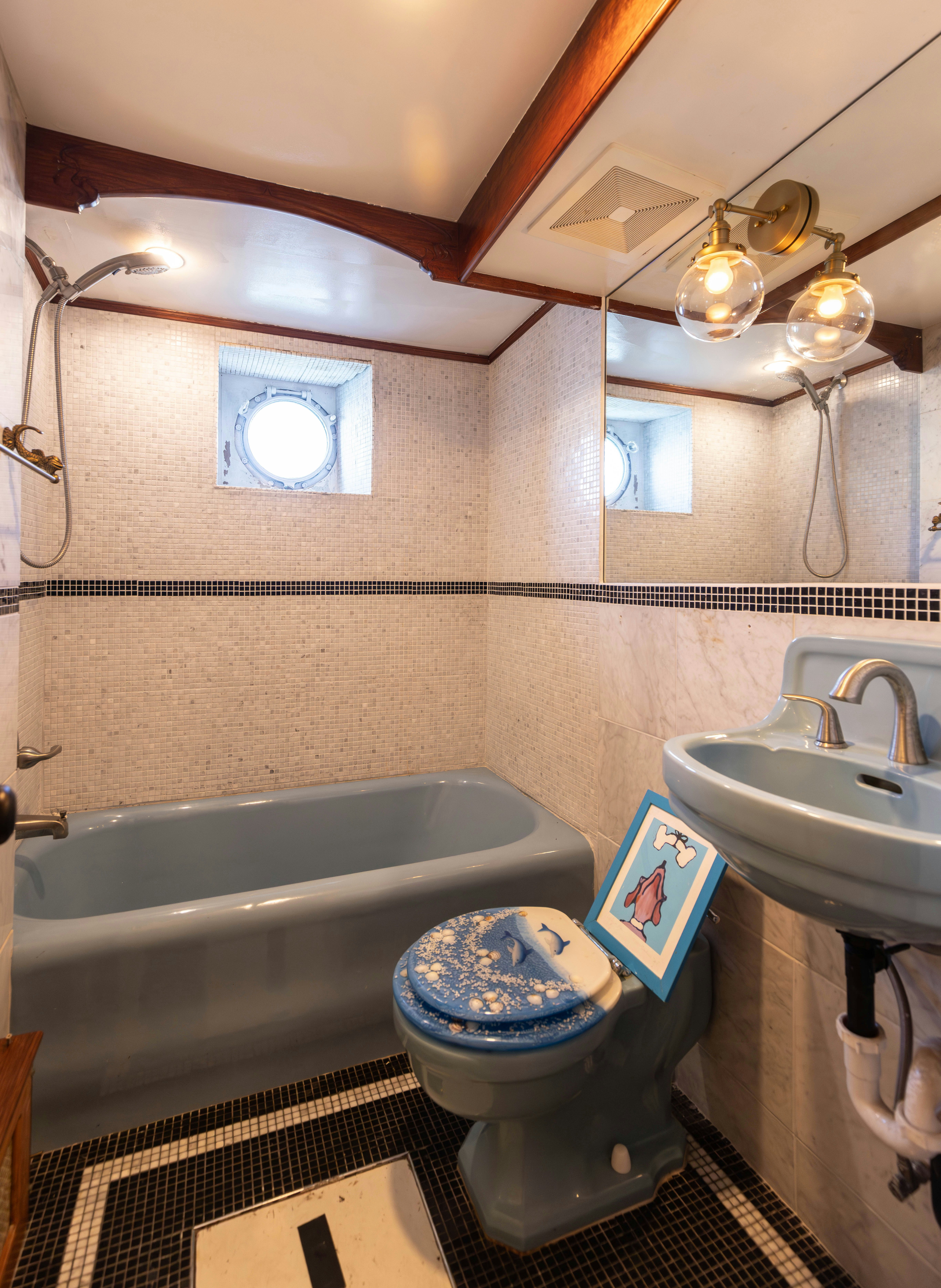 a bathroom with a blue toilet aboard NORTHWIND Yacht for Sale