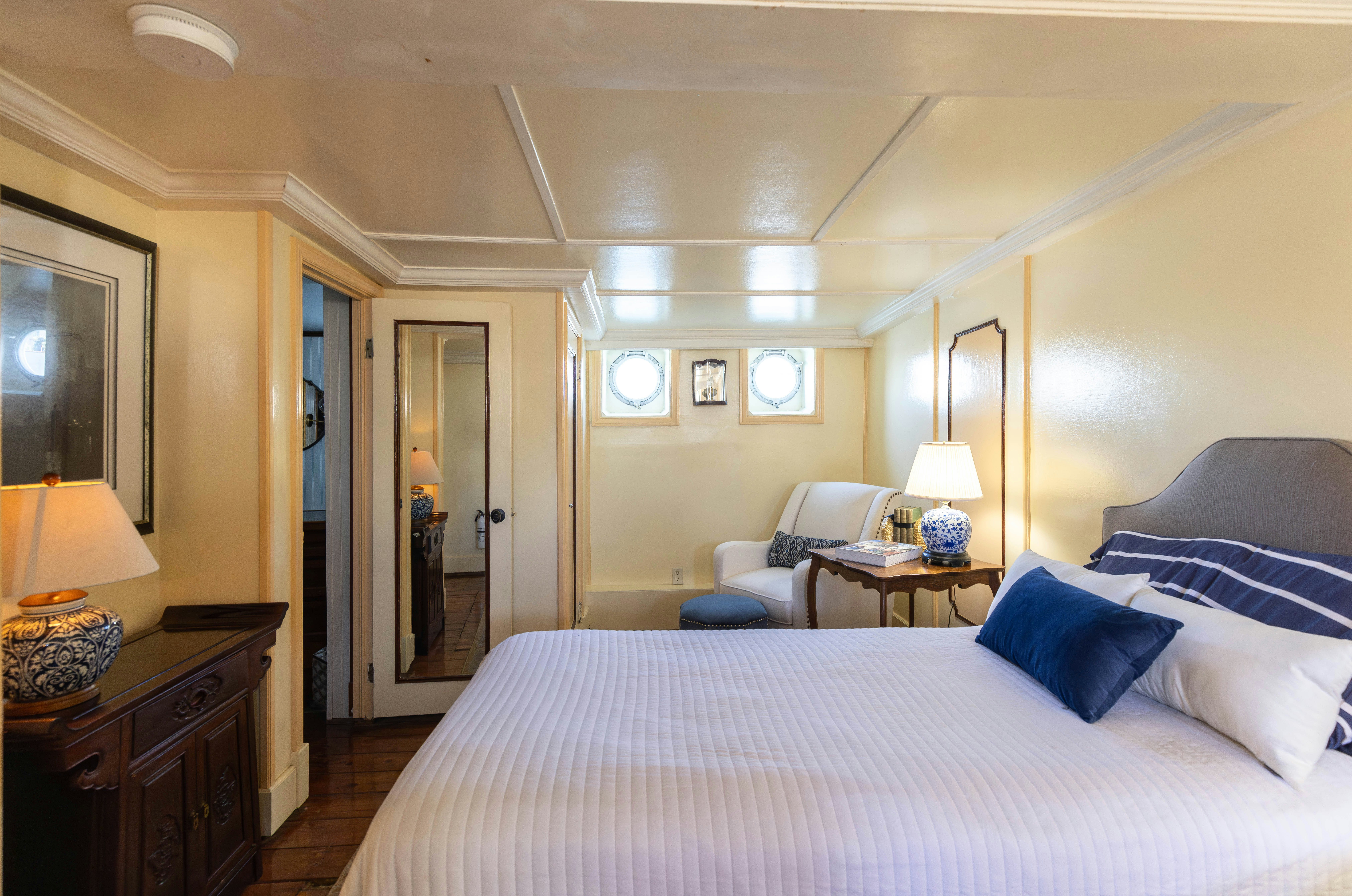 a bedroom with a bed and a chair aboard NORTHWIND Yacht for Sale