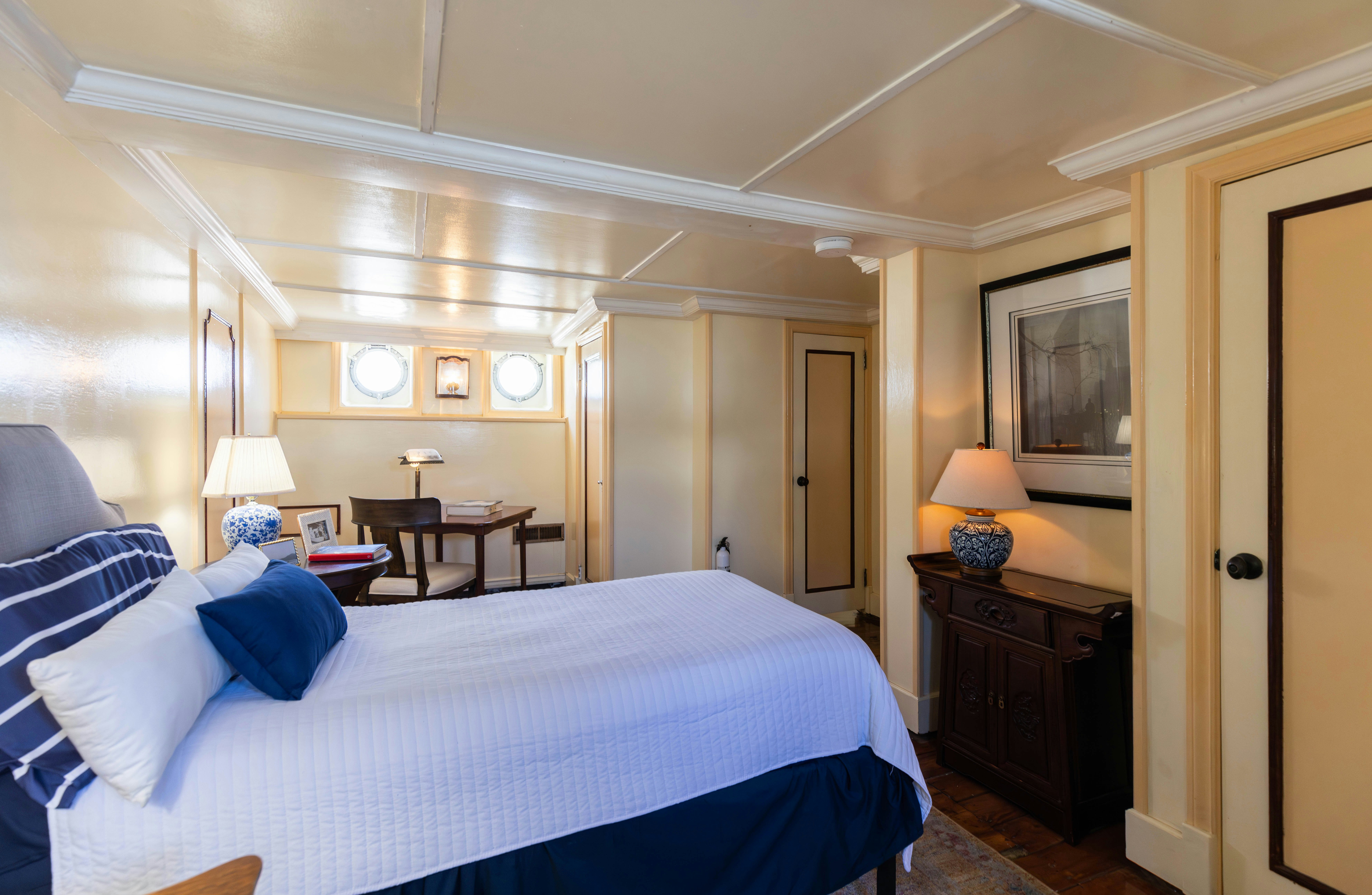 a bedroom with a bed and a desk aboard NORTHWIND Yacht for Sale