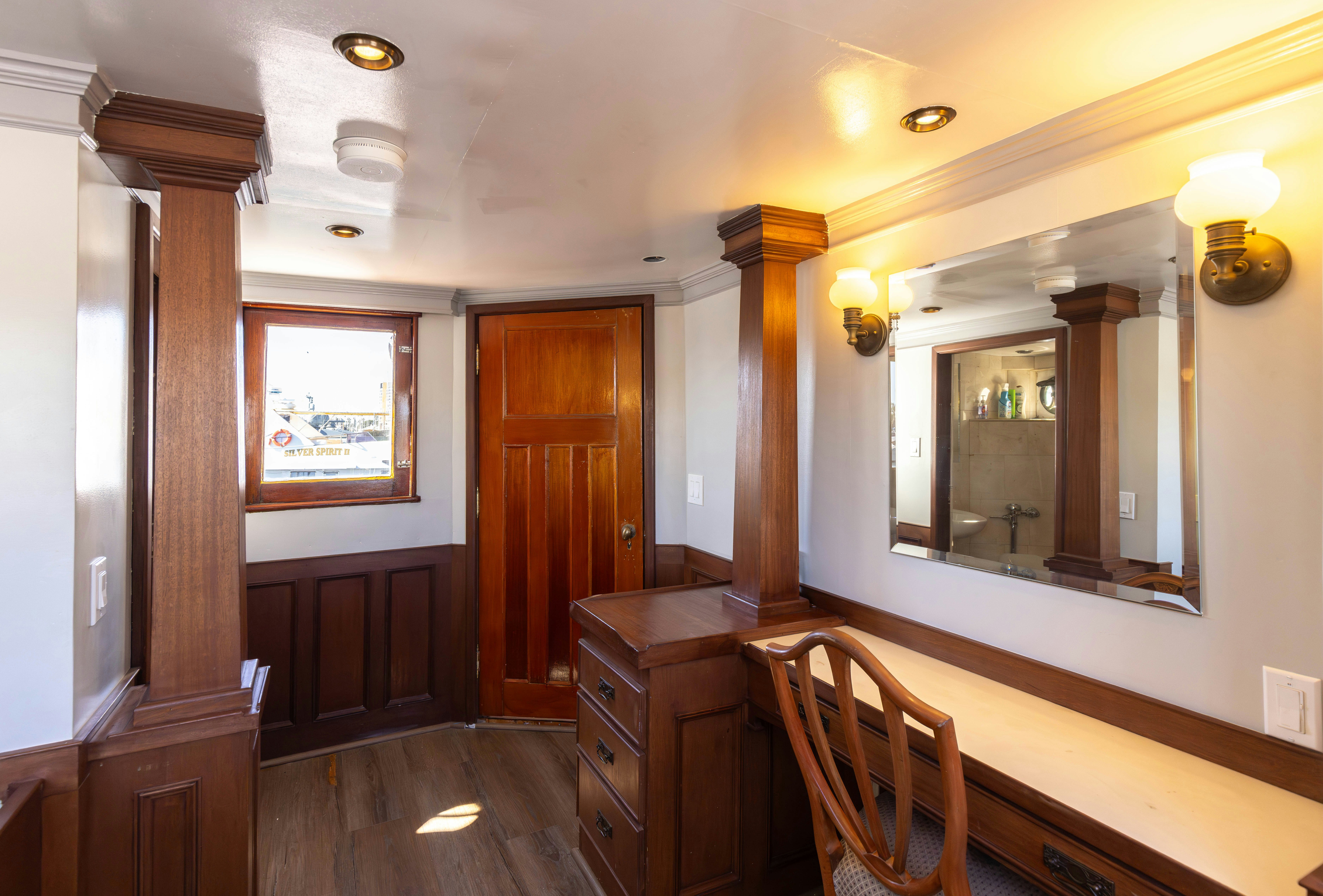 a room with a mirror and a chair aboard NORTHWIND Yacht for Sale