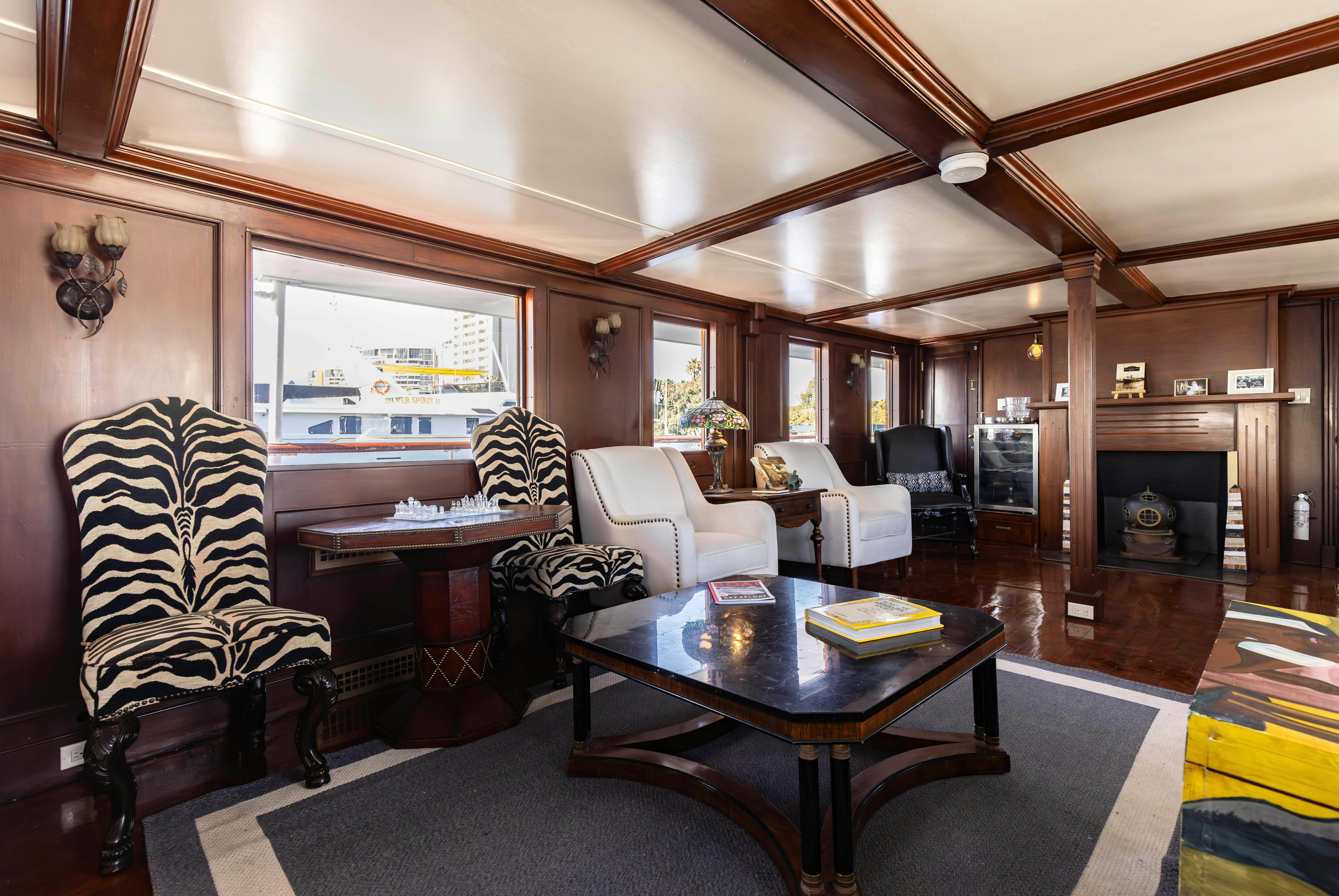 a living room with a table and chairs aboard NORTHWIND Yacht for Sale