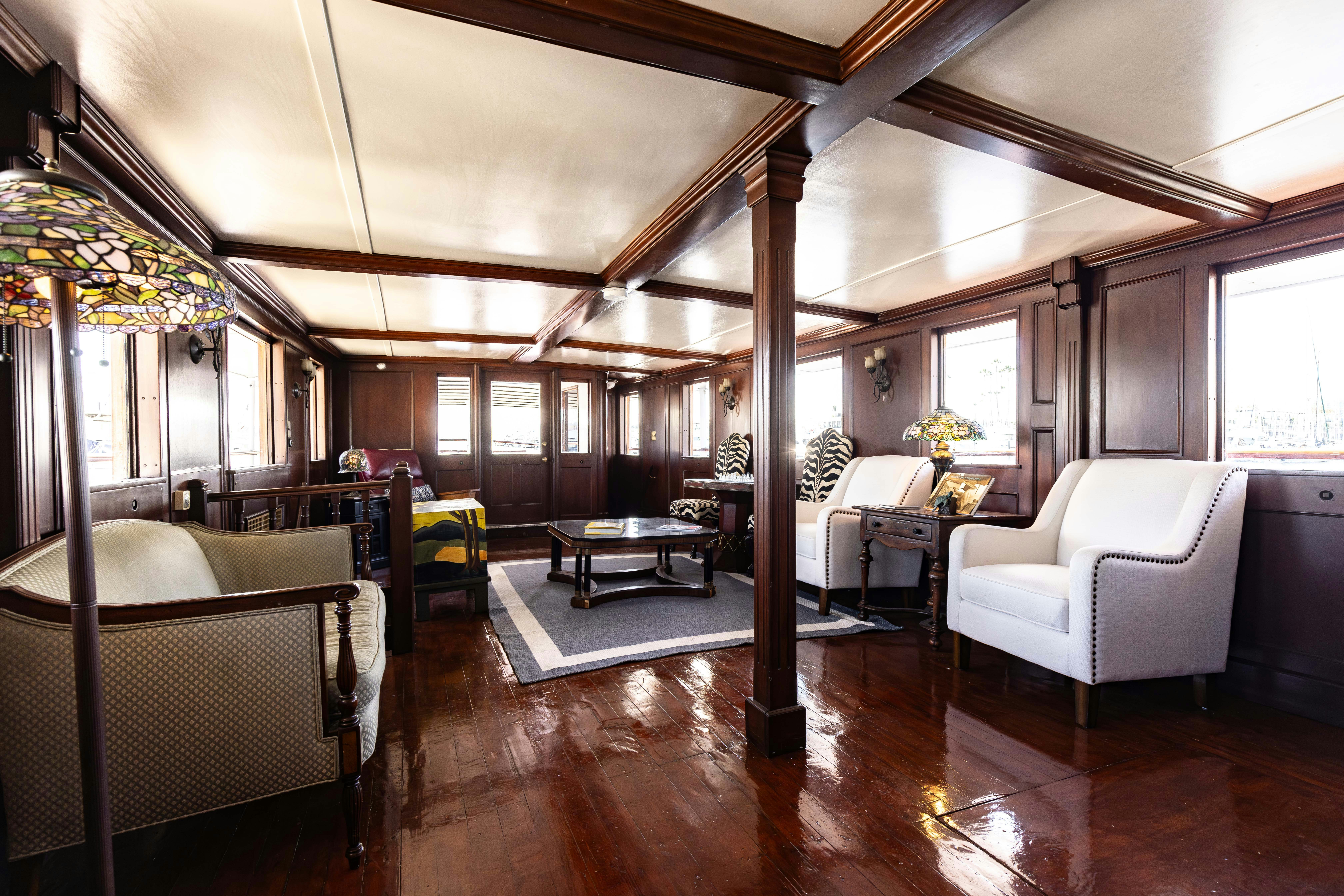 a room with a couch and a table and chairs aboard NORTHWIND Yacht for Sale