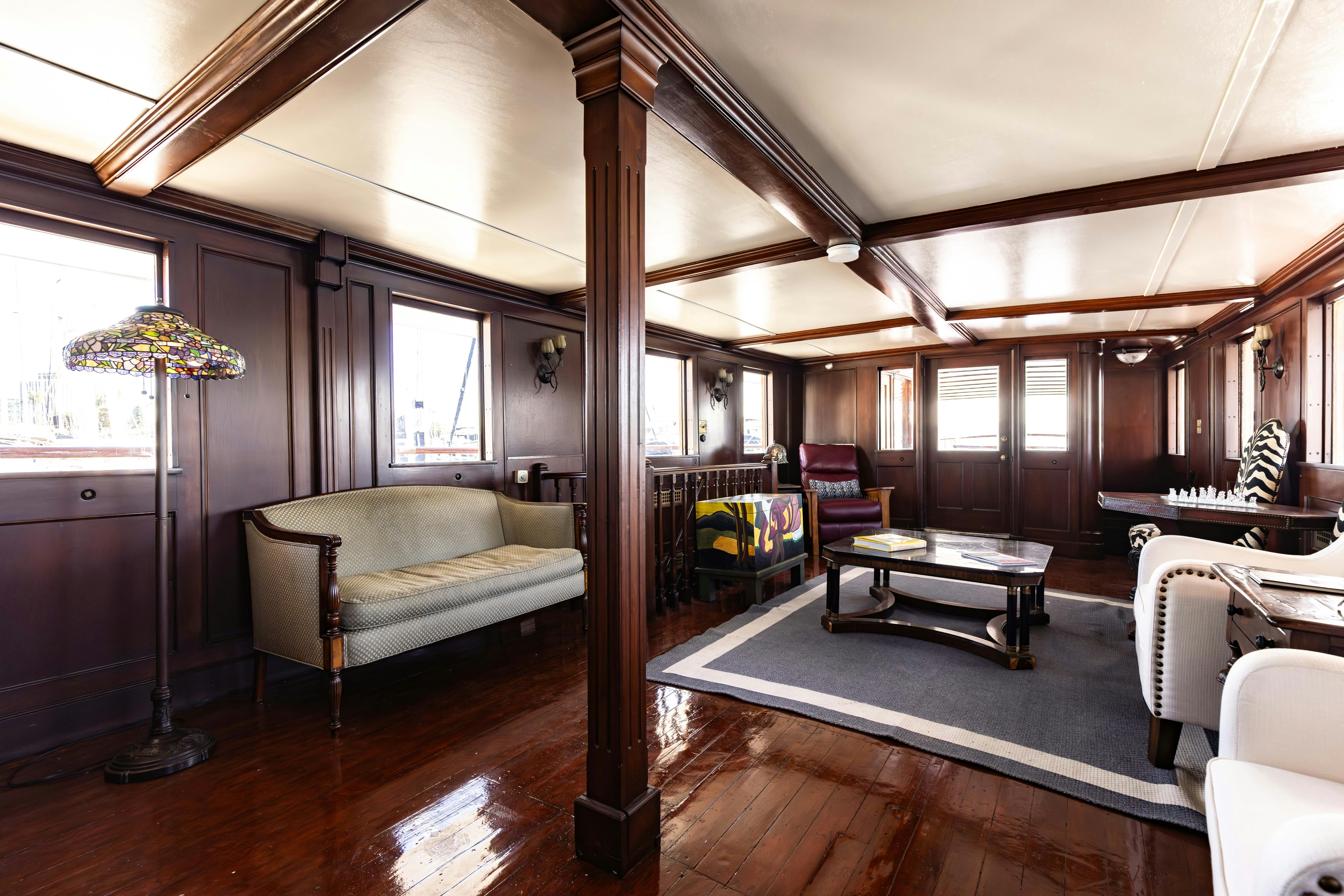 a room with a couch and a table aboard NORTHWIND Yacht for Sale