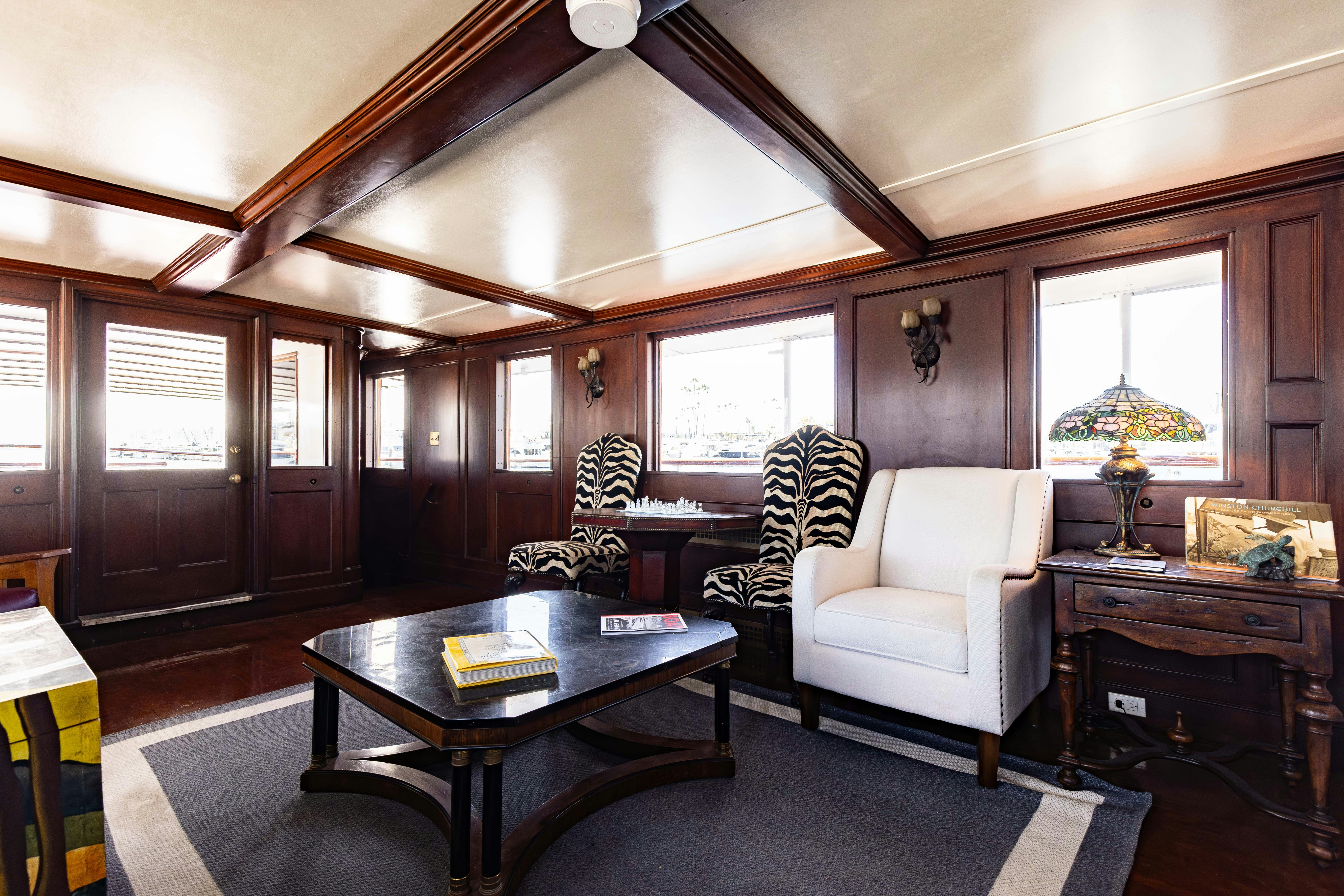 a living room with a table and chairs aboard NORTHWIND Yacht for Sale
