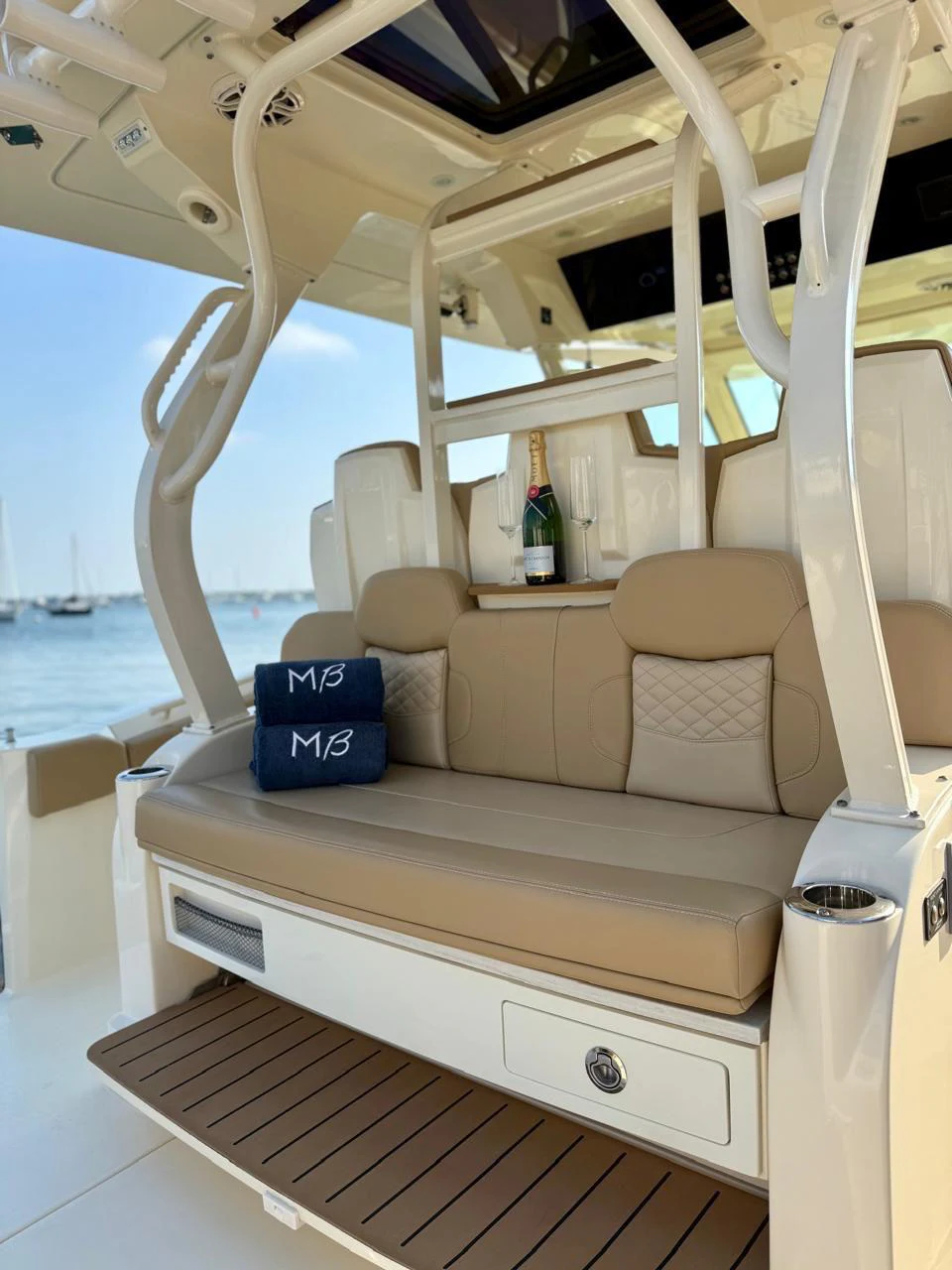 a boat with a couch and a table on it aboard SCOUT 400LXF Yacht for Sale