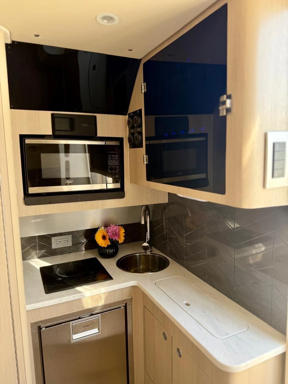 a kitchen with a sink and microwave aboard SCOUT 400LXF Yacht for Sale