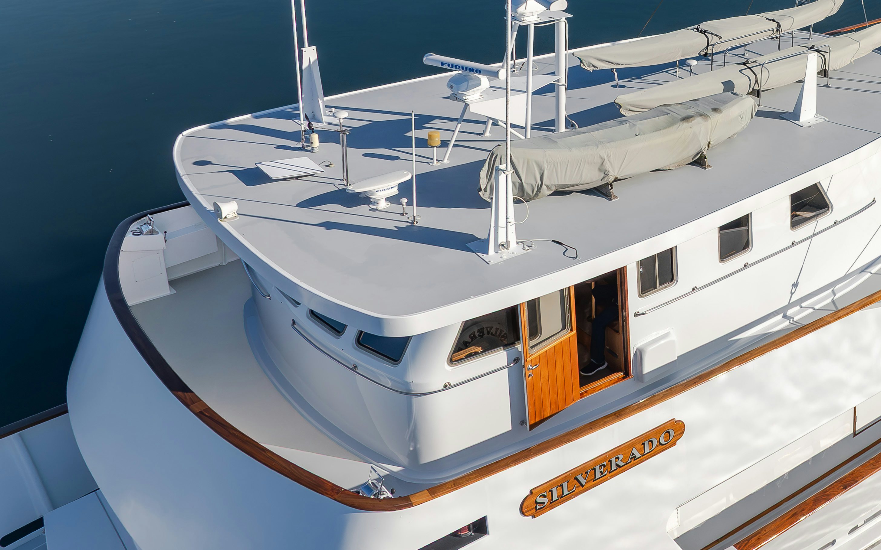 a white boat with a white sail aboard SILVERADO Yacht for Sale