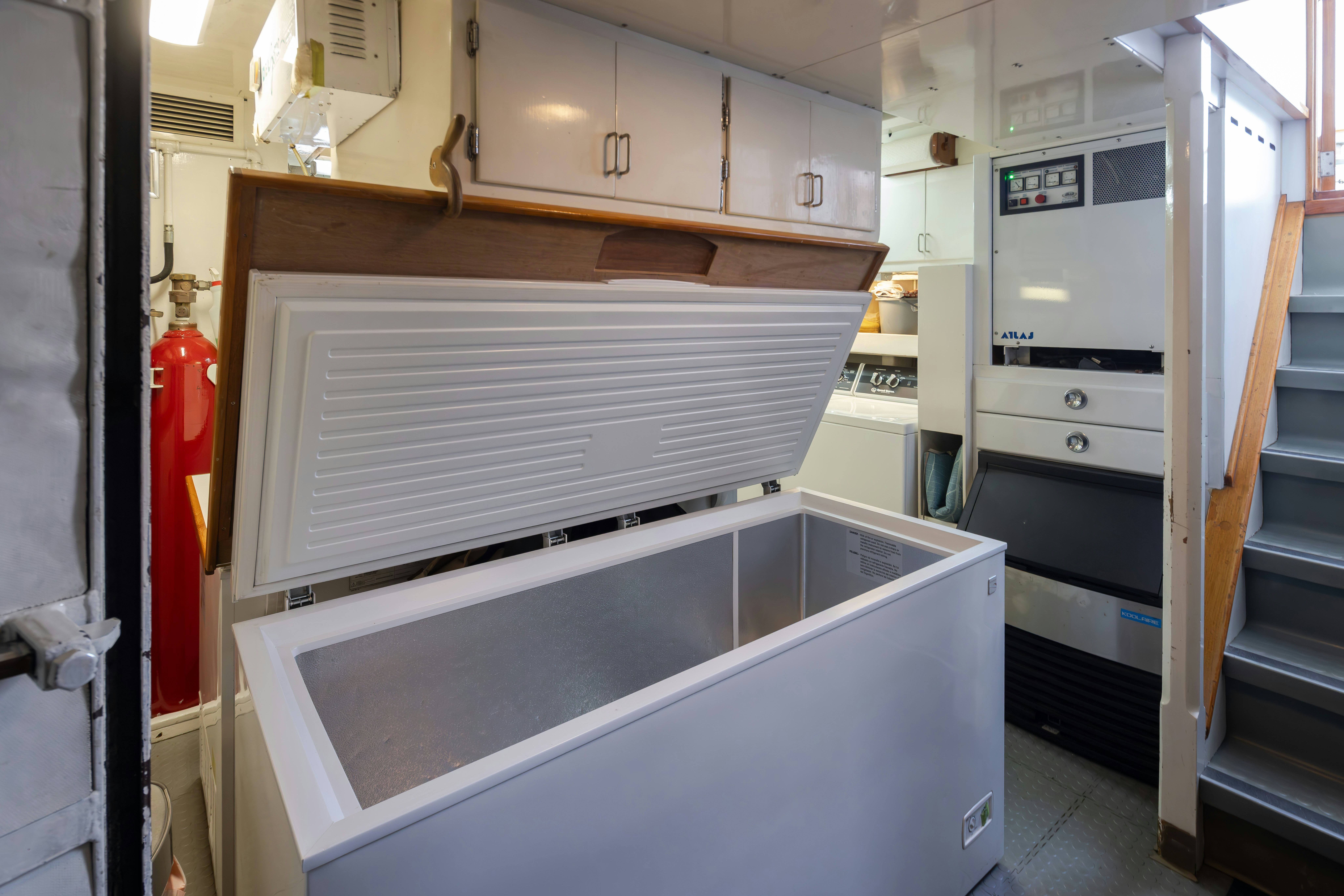 a kitchen with white cabinets aboard SILVERADO Yacht for Sale