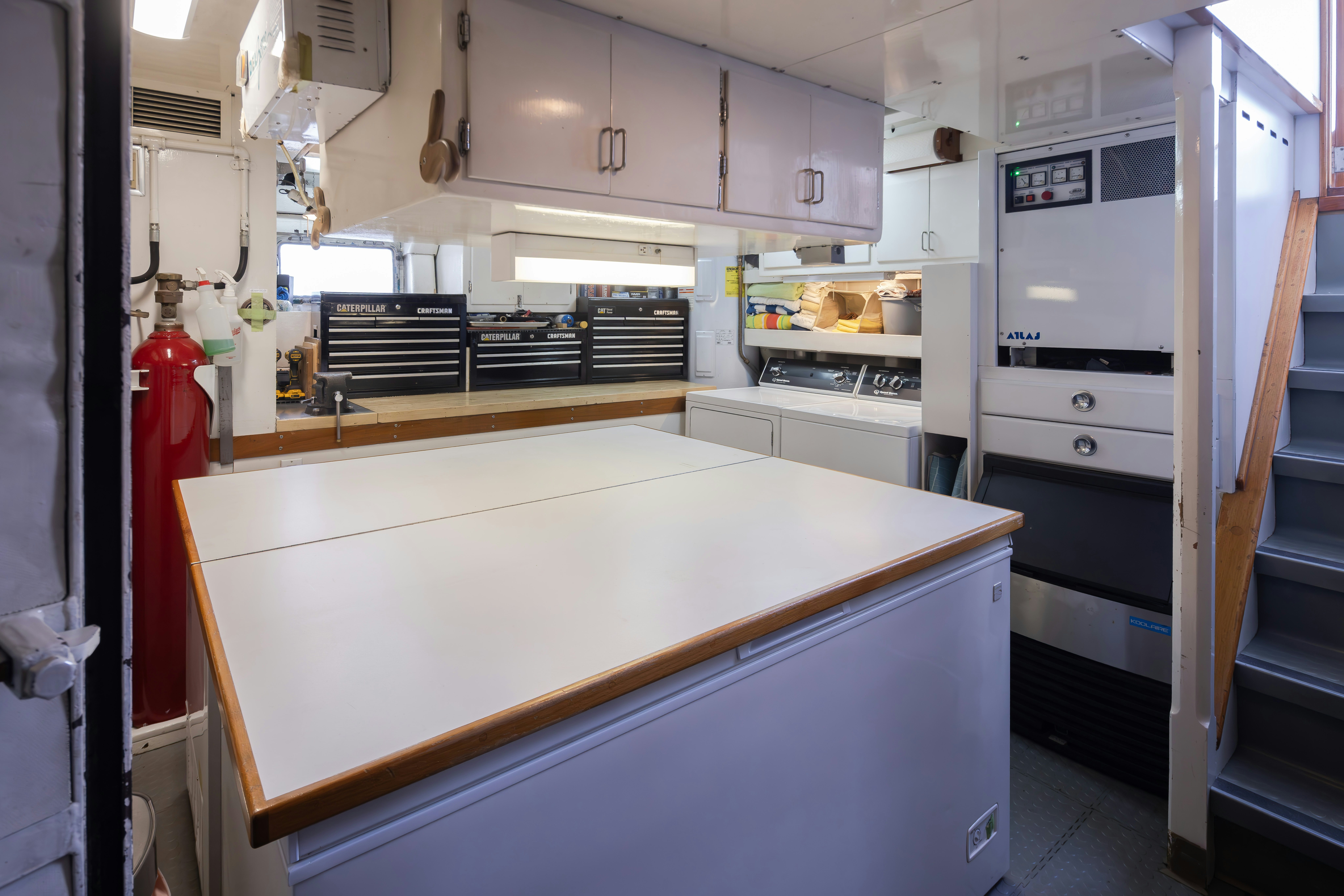 a kitchen with white cabinets aboard SILVERADO Yacht for Sale
