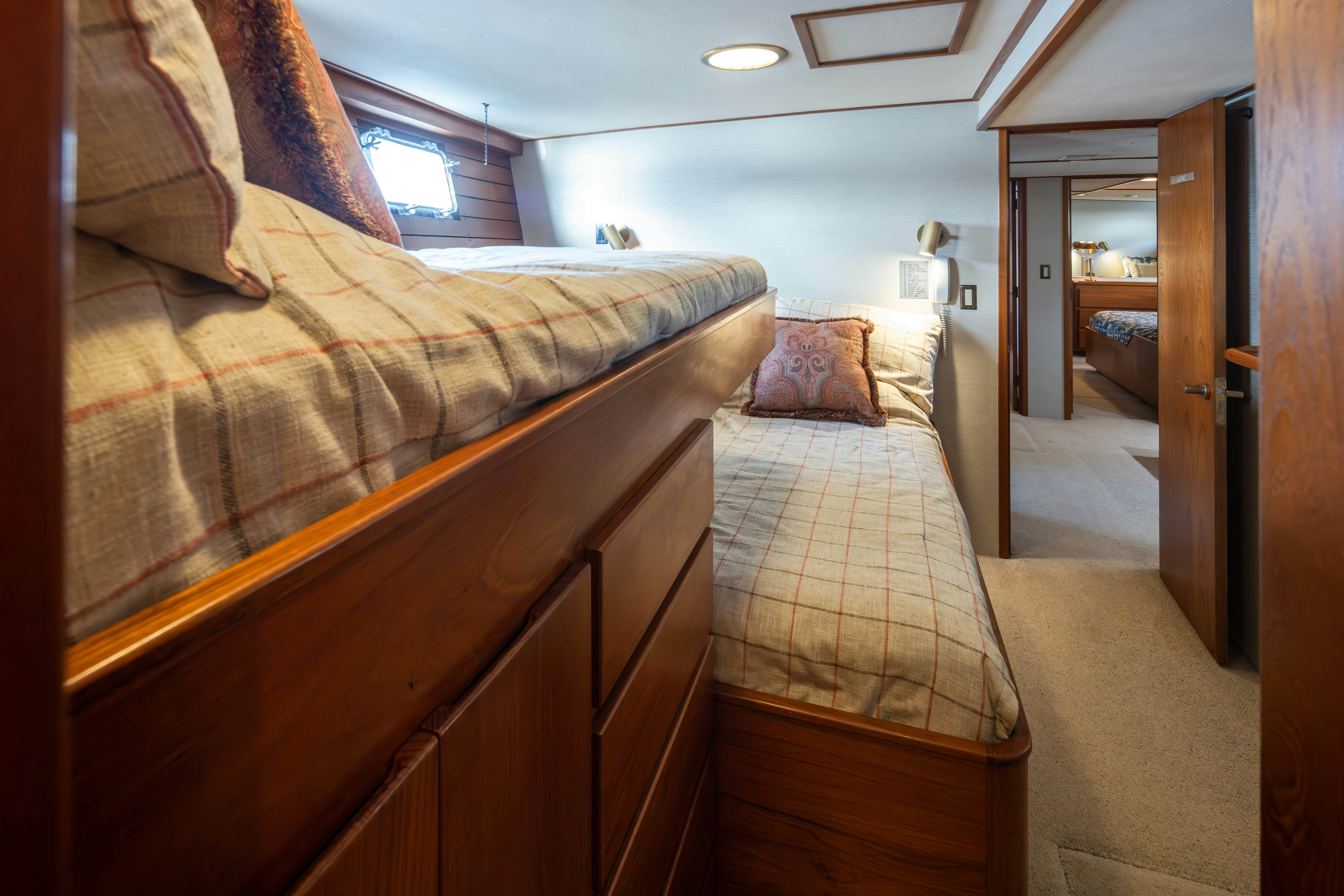 a bedroom with a bed and a door aboard SILVERADO Yacht for Sale