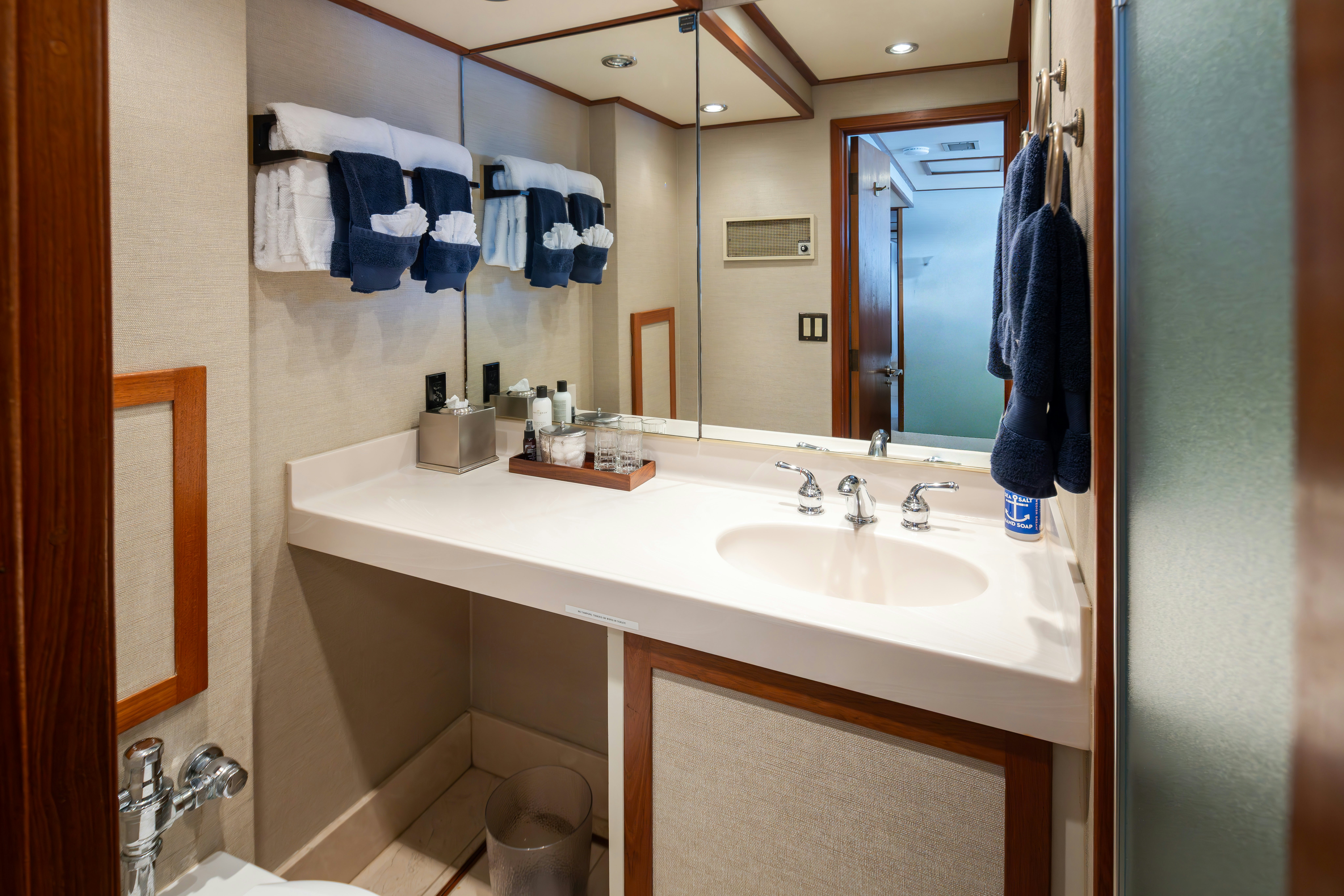 a bathroom with a sink and mirror aboard SILVERADO Yacht for Sale