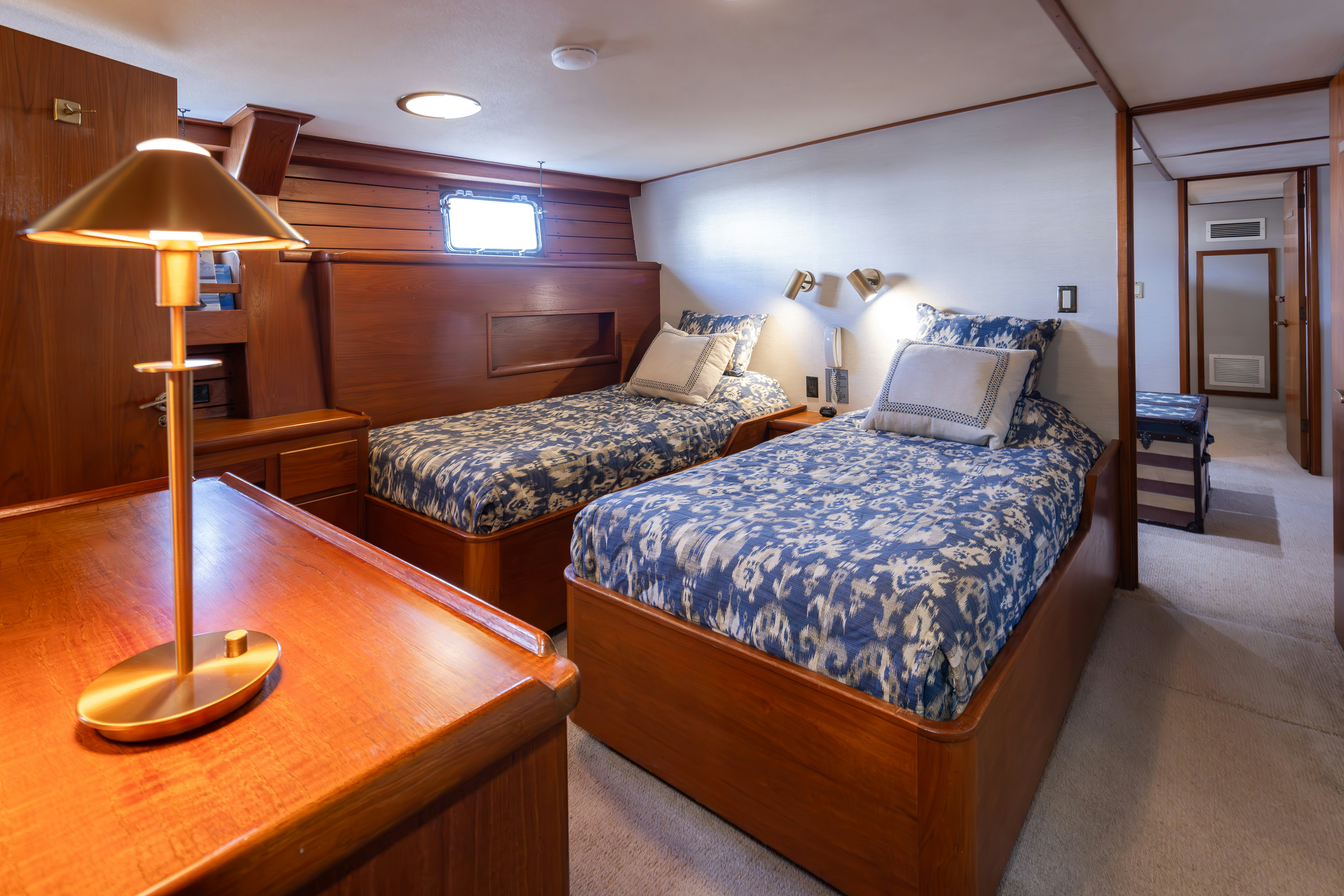 a bedroom with a bed and a lamp aboard SILVERADO Yacht for Sale
