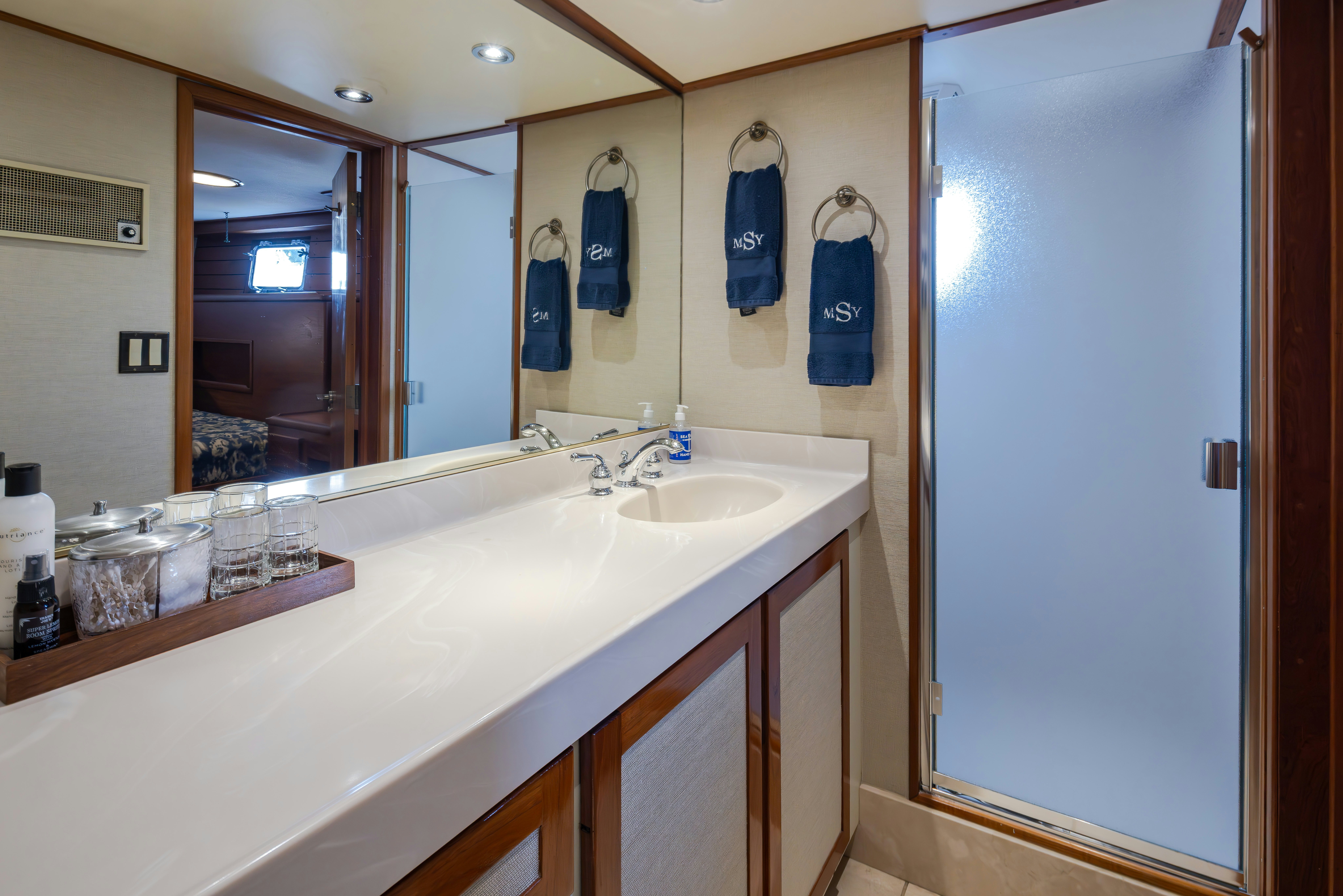 a bathroom with a countertop sink and mirror aboard SILVERADO Yacht for Sale