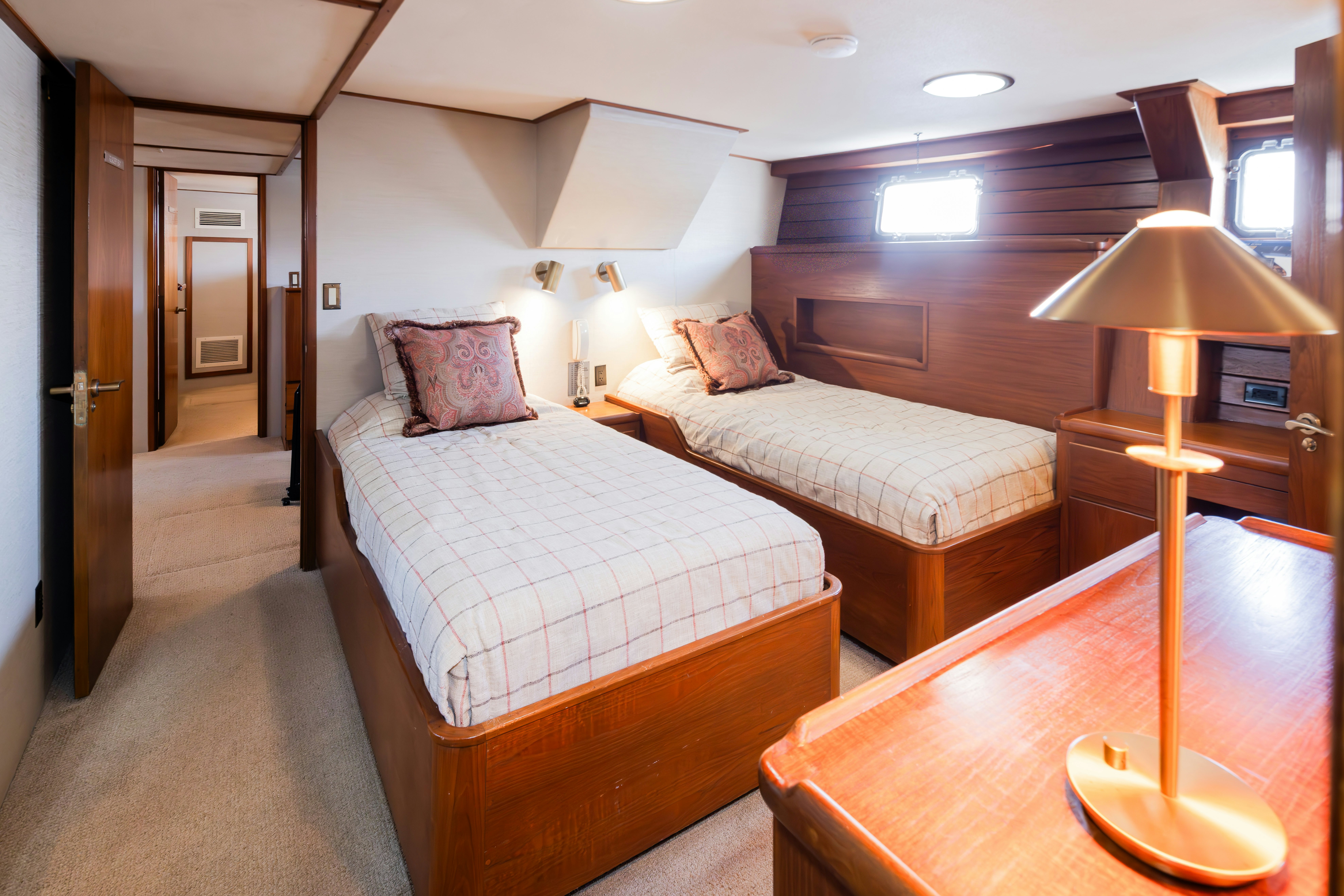 a bedroom with a bed and a lamp aboard SILVERADO Yacht for Sale