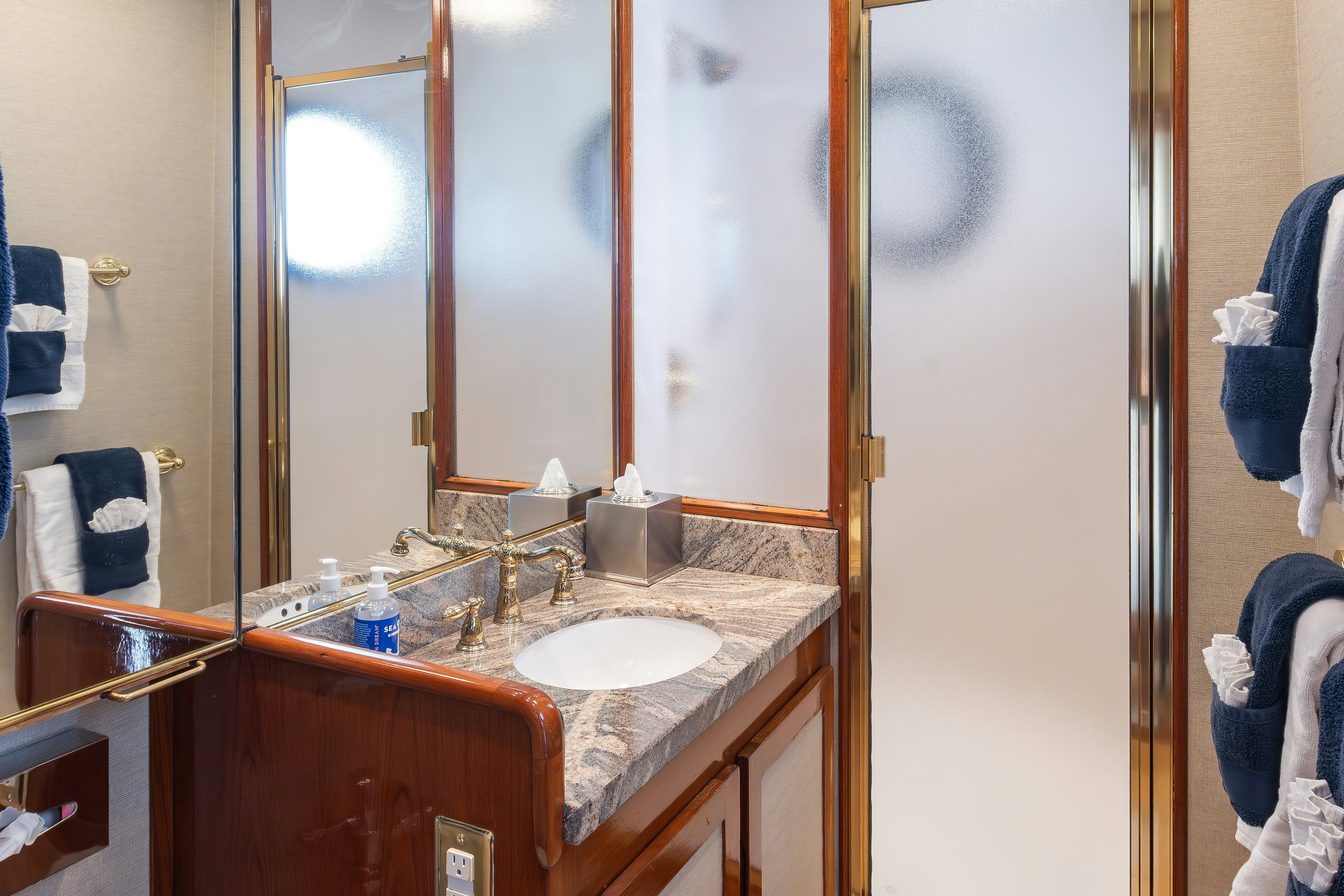 a bathroom with a sink and mirror aboard SILVERADO Yacht for Sale