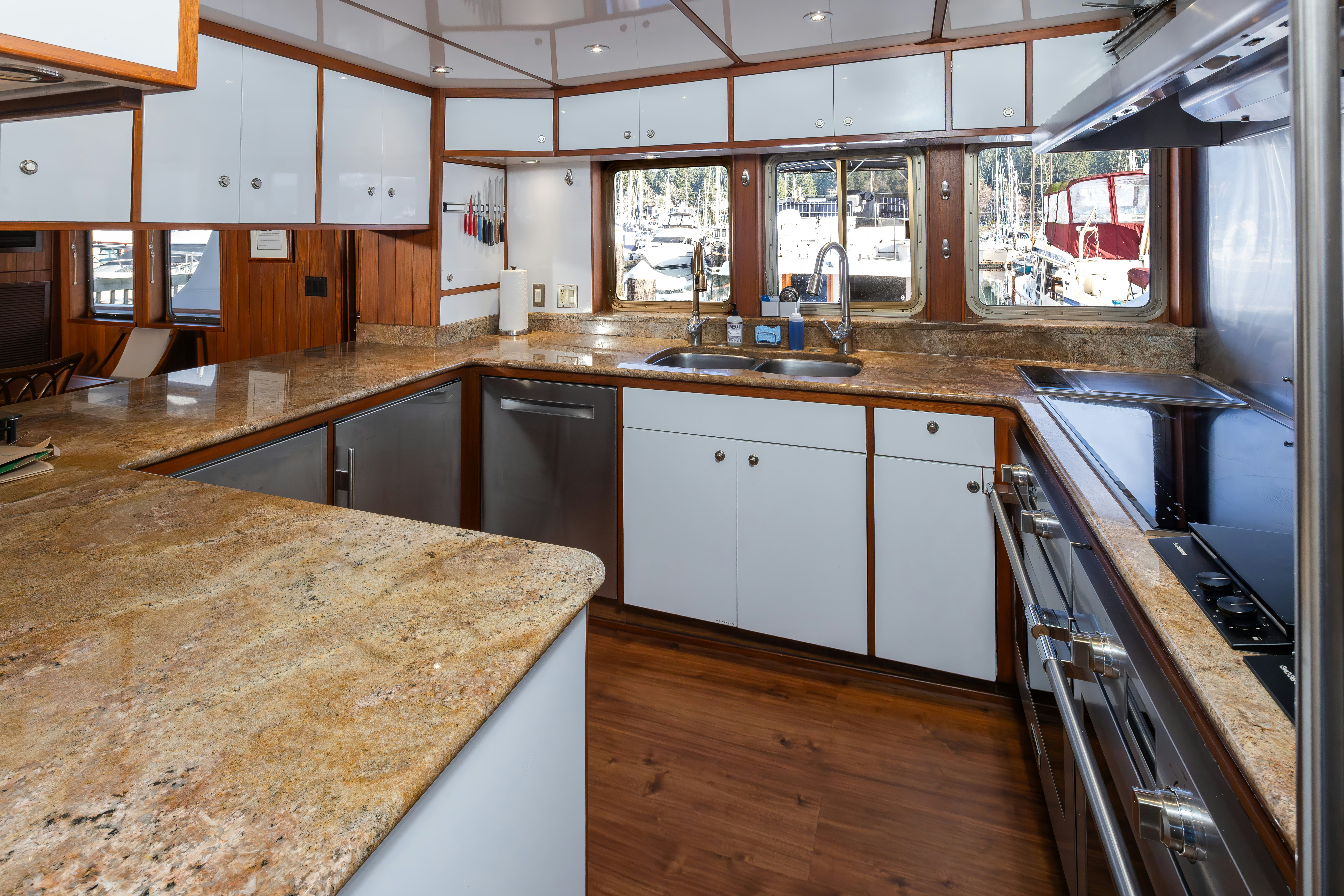 a kitchen with a large island aboard SILVERADO Yacht for Sale