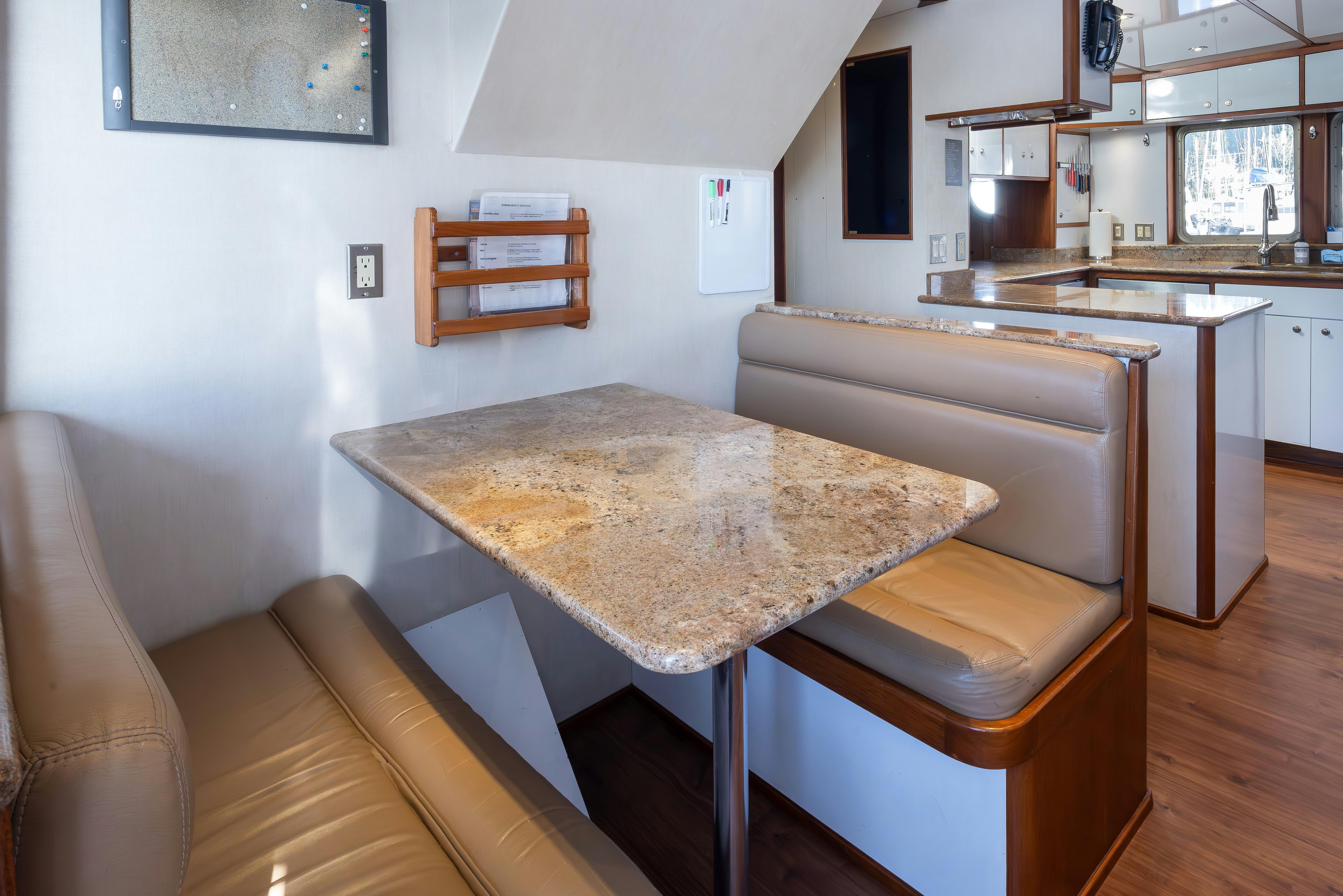 a kitchen with a table and chairs aboard SILVERADO Yacht for Sale