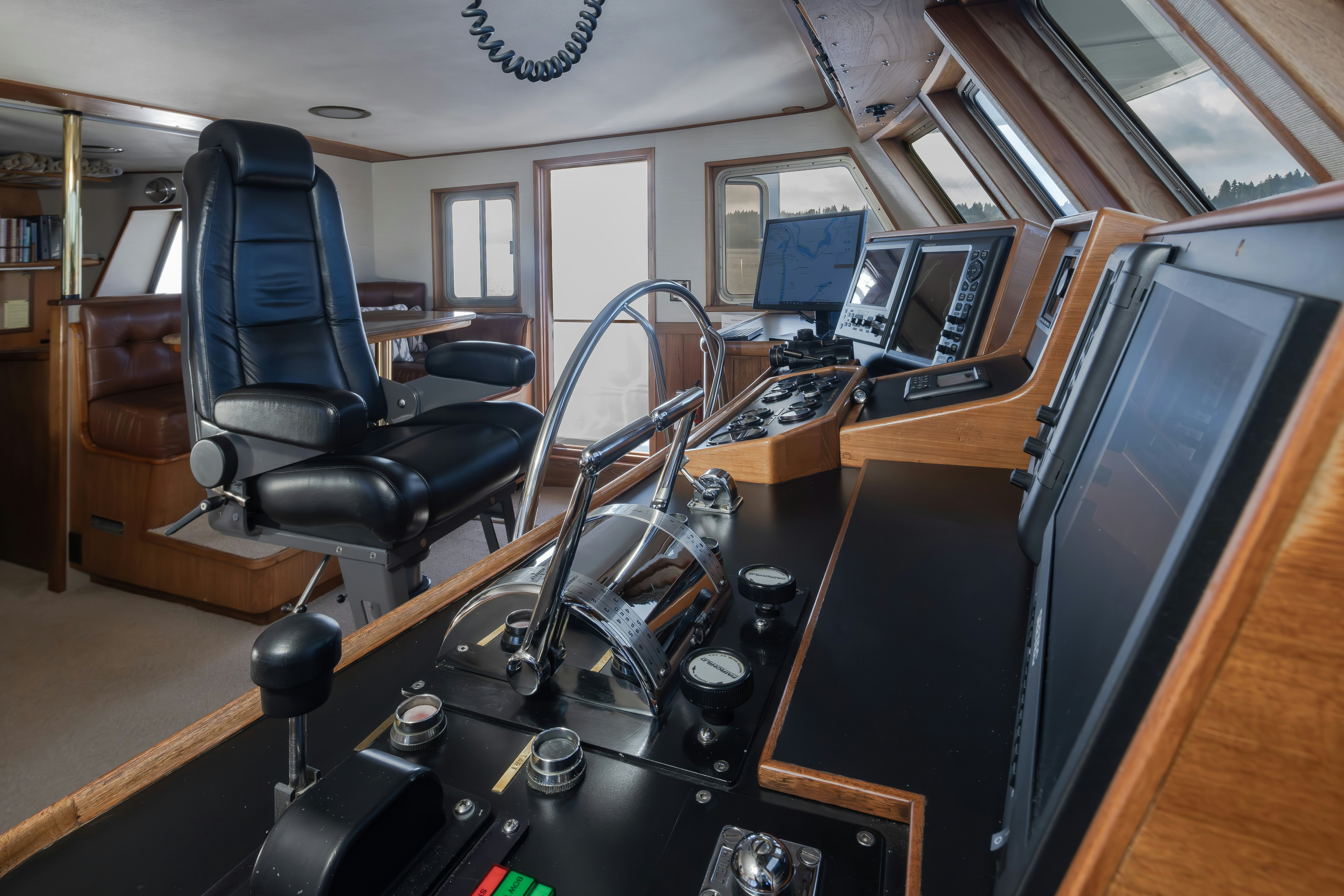 a room with a desk and chairs aboard SILVERADO Yacht for Sale