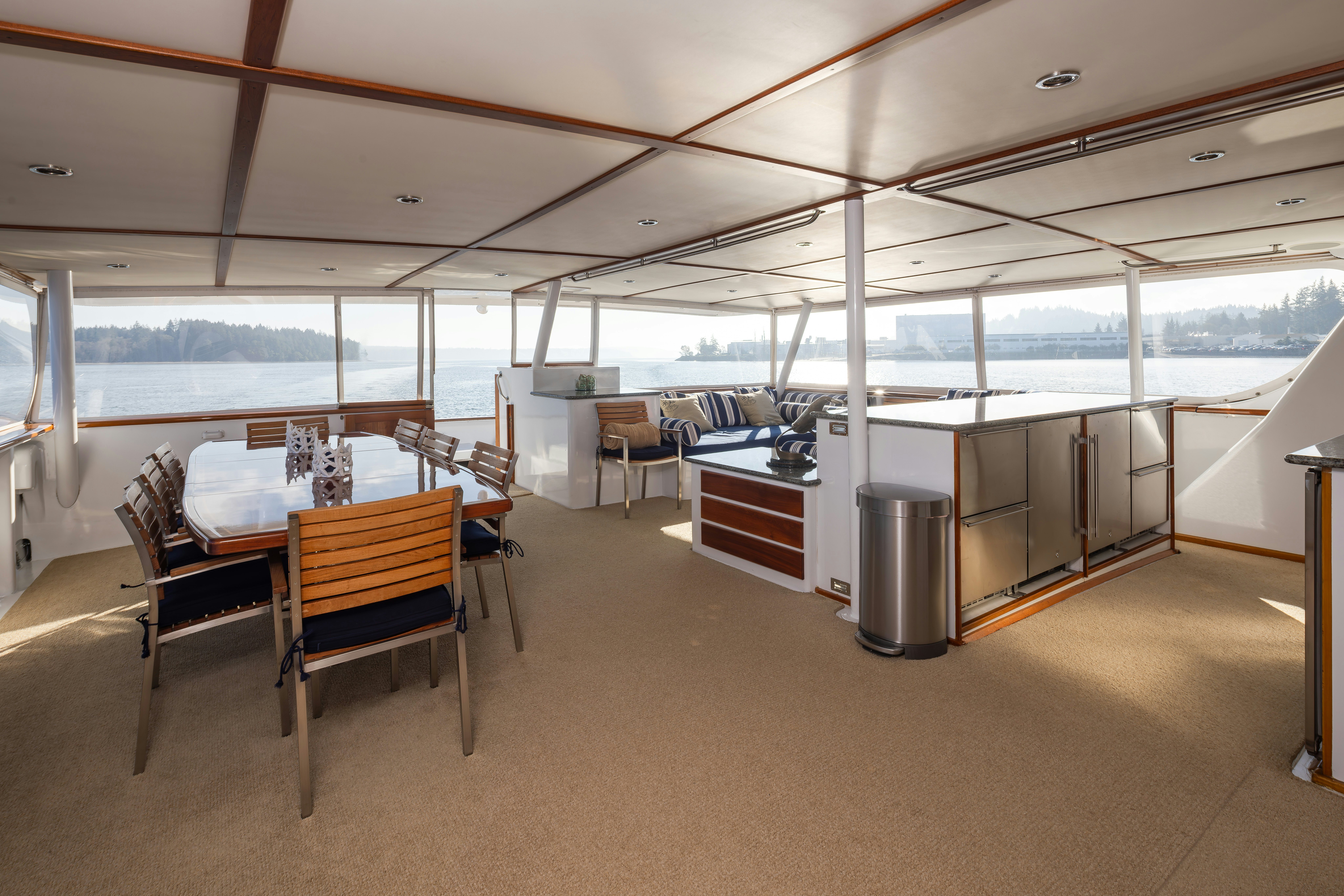 a large room with a table and chairs aboard SILVERADO Yacht for Sale