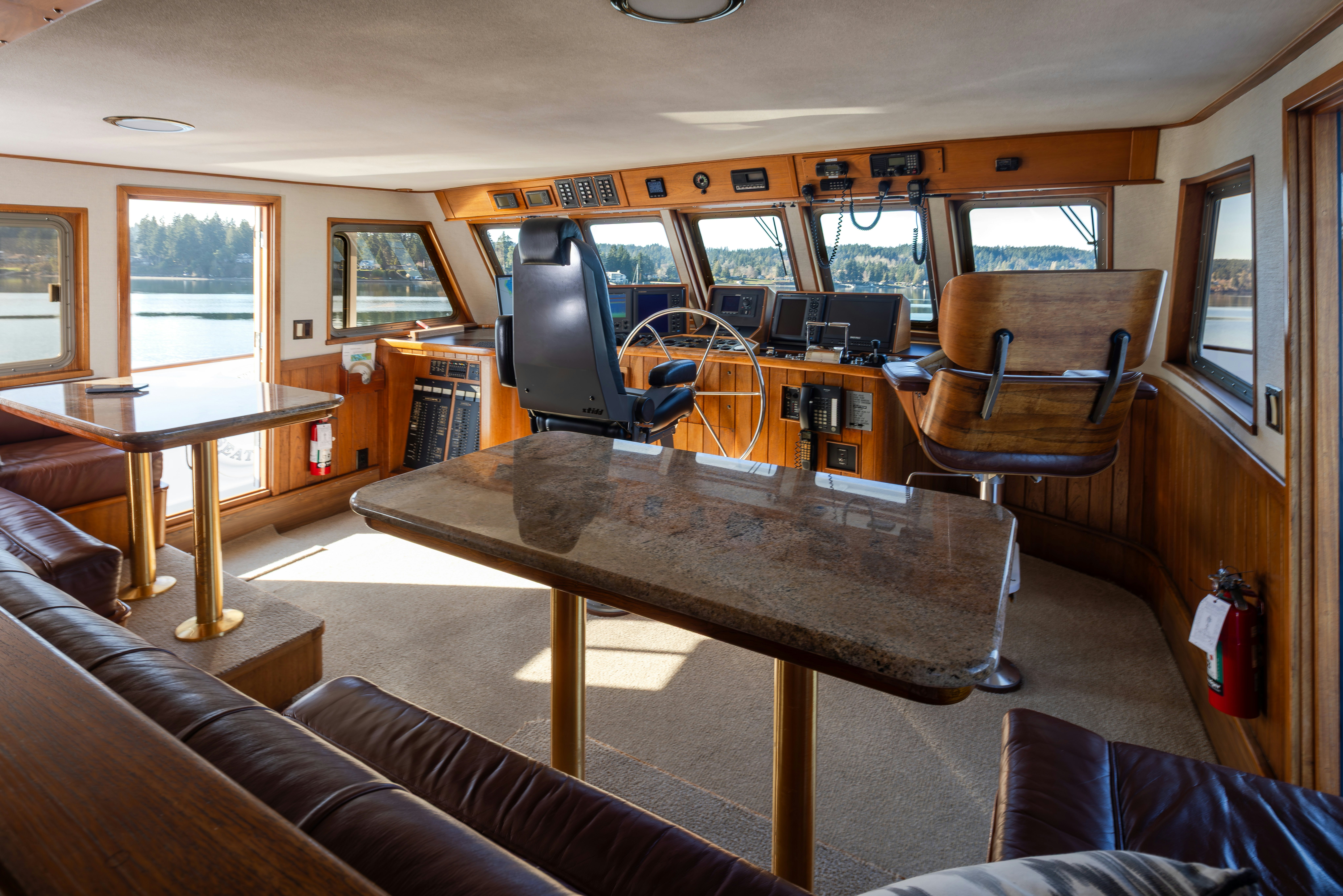 a living room with a table and chairs aboard SILVERADO Yacht for Sale