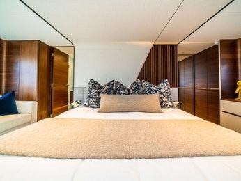 a bed with a brown comforter aboard RECORD YEAR Yacht for Charter