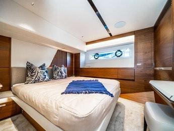 a bedroom with a bed and a large mirror aboard RECORD YEAR Yacht for Charter