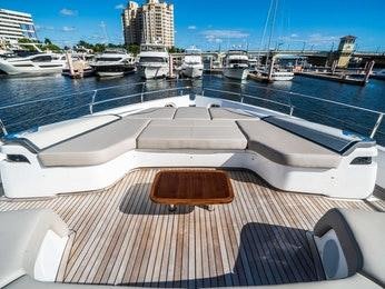a deck with a view of a marina and boats aboard RECORD YEAR Yacht for Charter