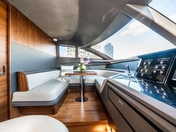 a room with a table and couch aboard RECORD YEAR Yacht for Charter