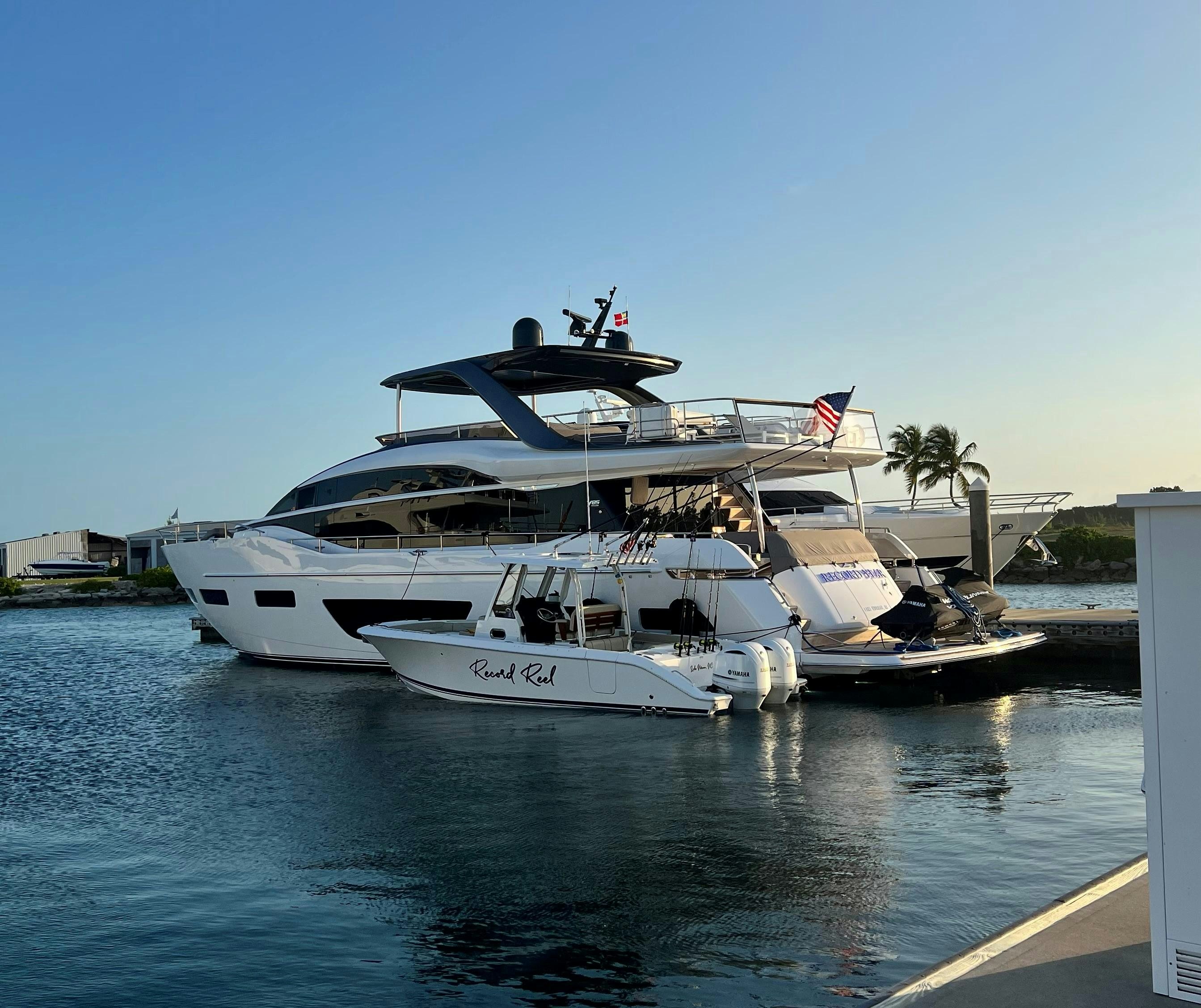 a large boat docked at a pier aboard RECORD YEAR Yacht for Charter