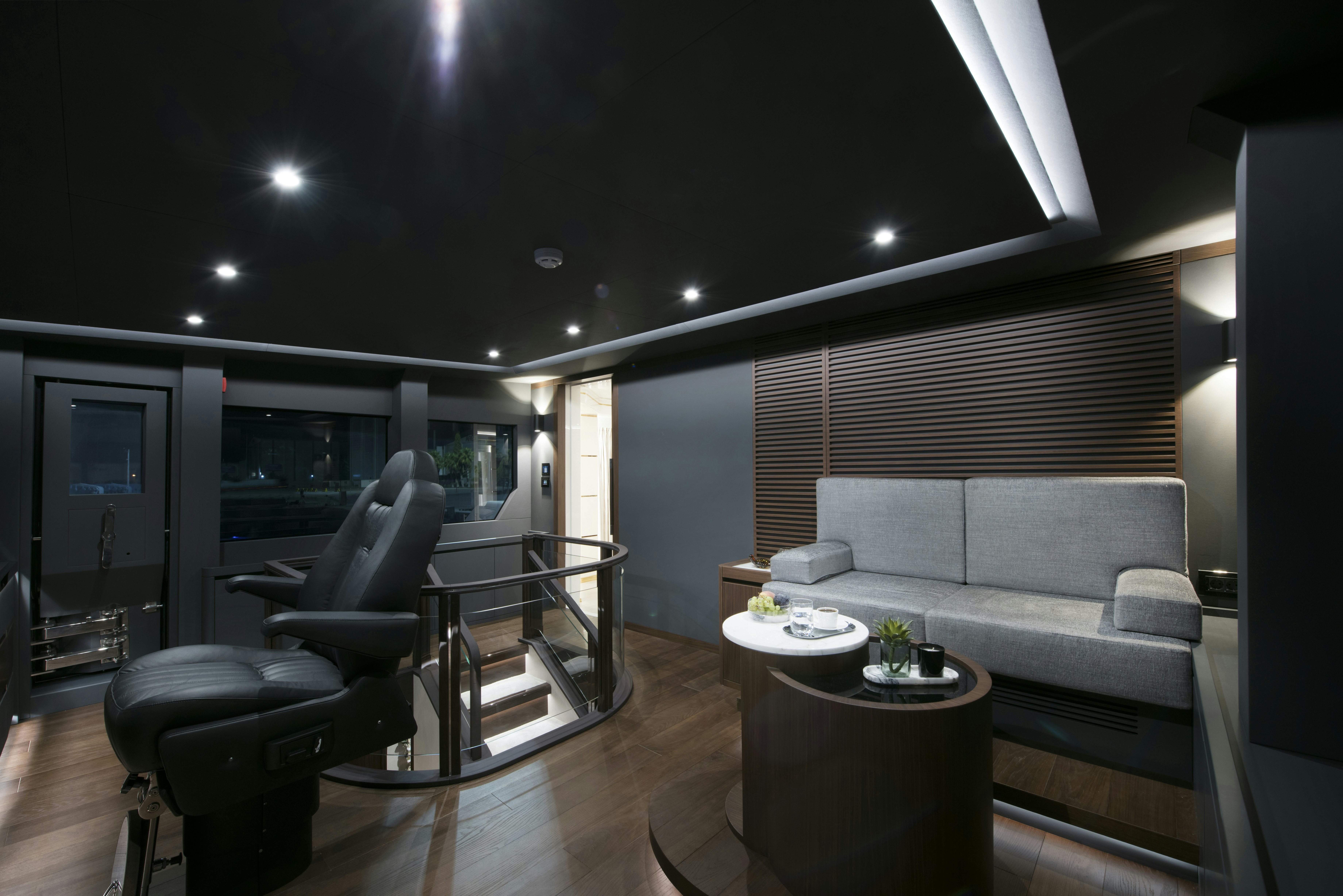 a living room with a couch and a table aboard LAZZARA UHV 100 Yacht for Sale