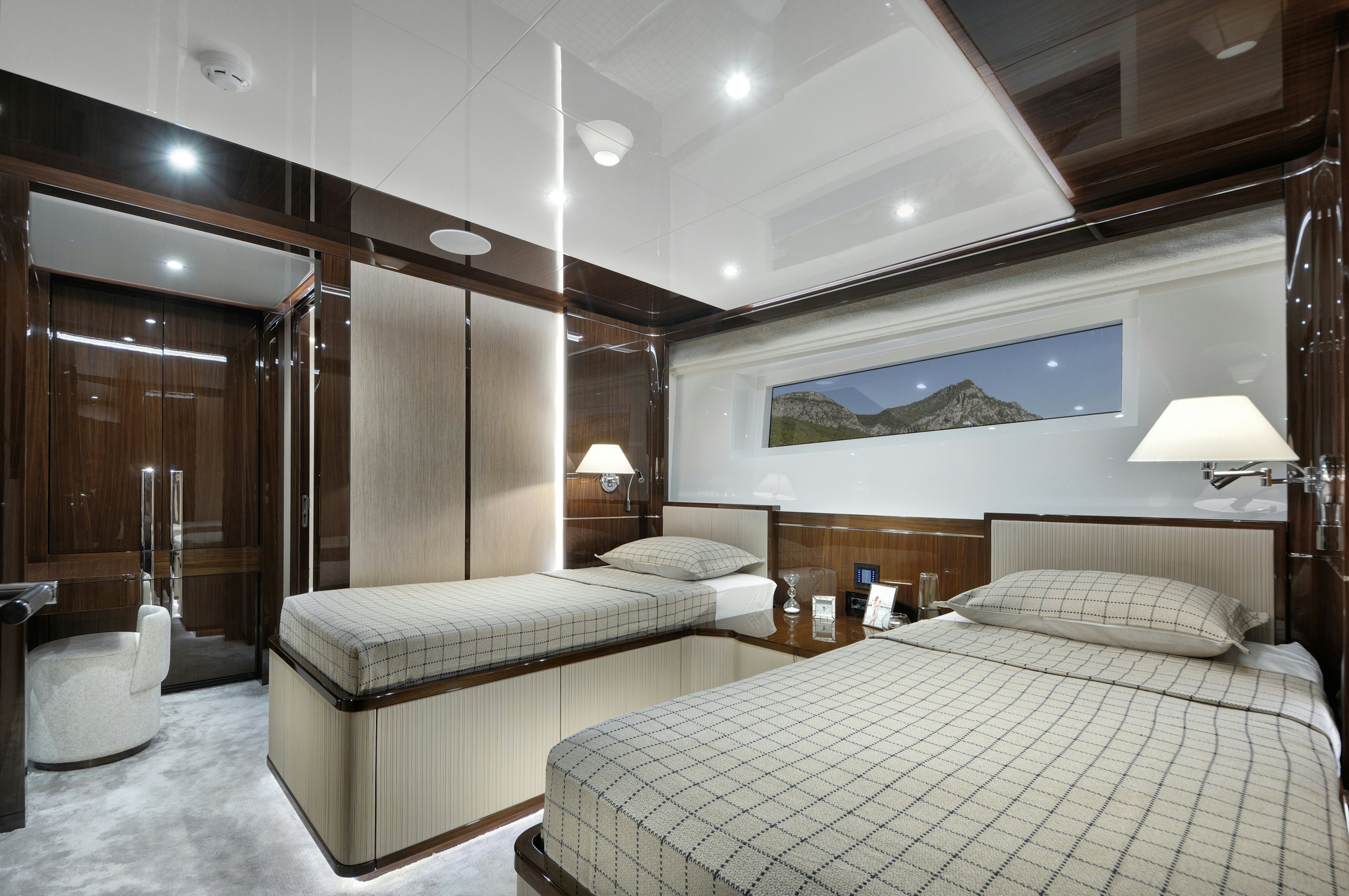a room with a bed and a mirror aboard LAZZARA UHV 100 Yacht for Sale