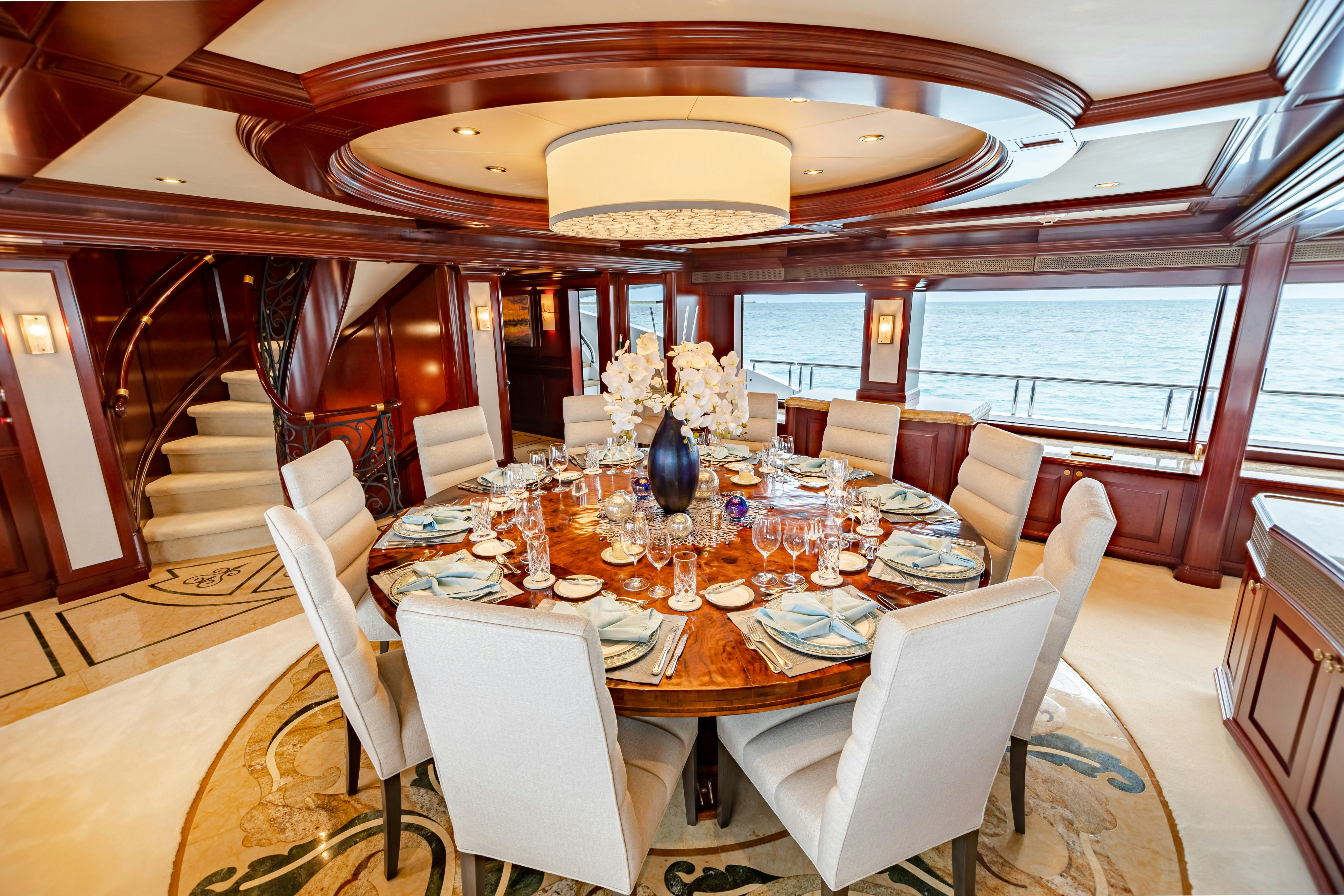 a dining room with a table set for a dinner aboard MISS STEPHANIE Yacht for Charter