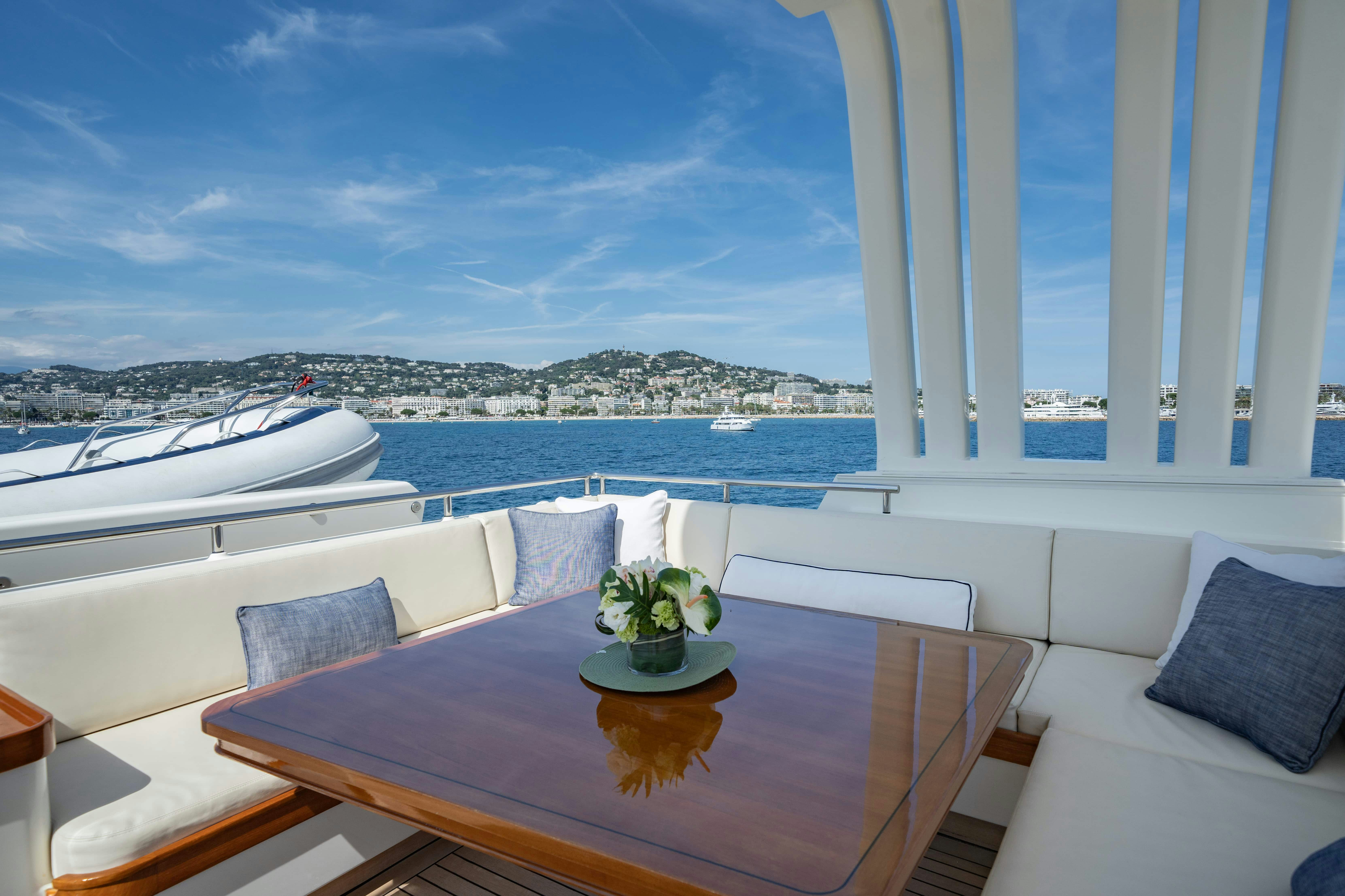 a table with a plant on it aboard FABULOUS CHARACTER Yacht for Charter