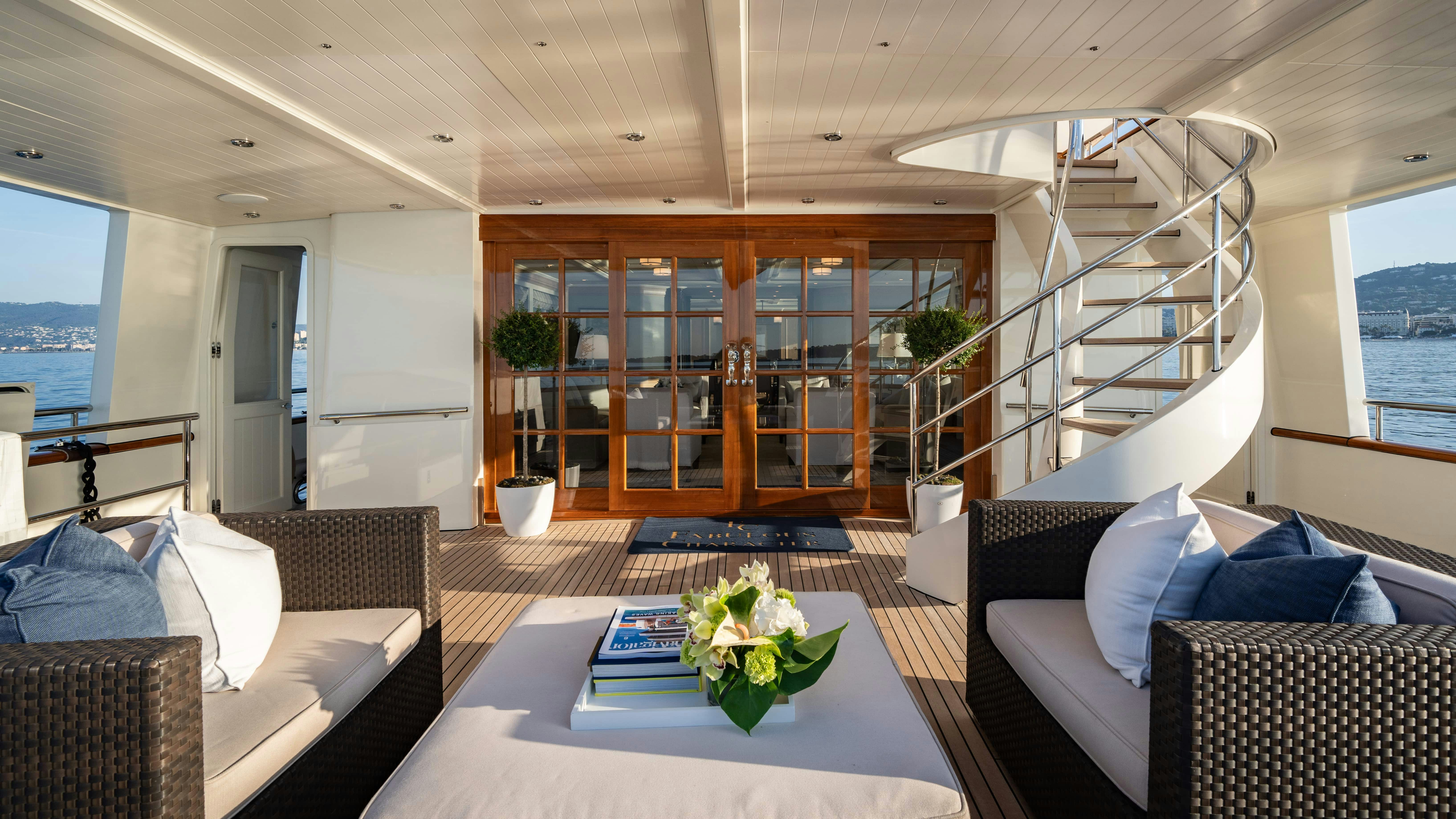 a living room with a table and couches aboard FABULOUS CHARACTER Yacht for Charter