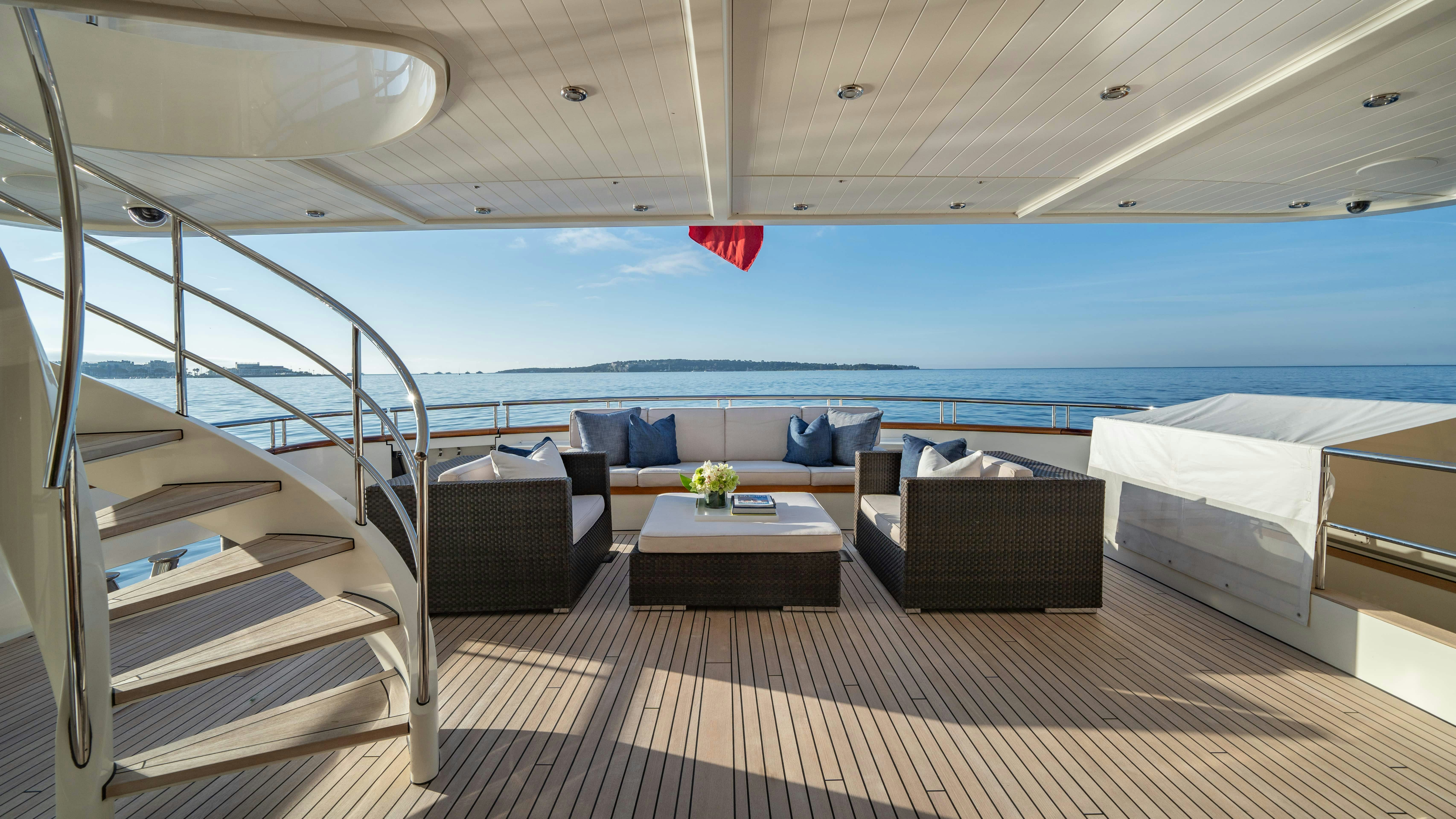 a room with a bed and a table on a deck aboard FABULOUS CHARACTER Yacht for Charter