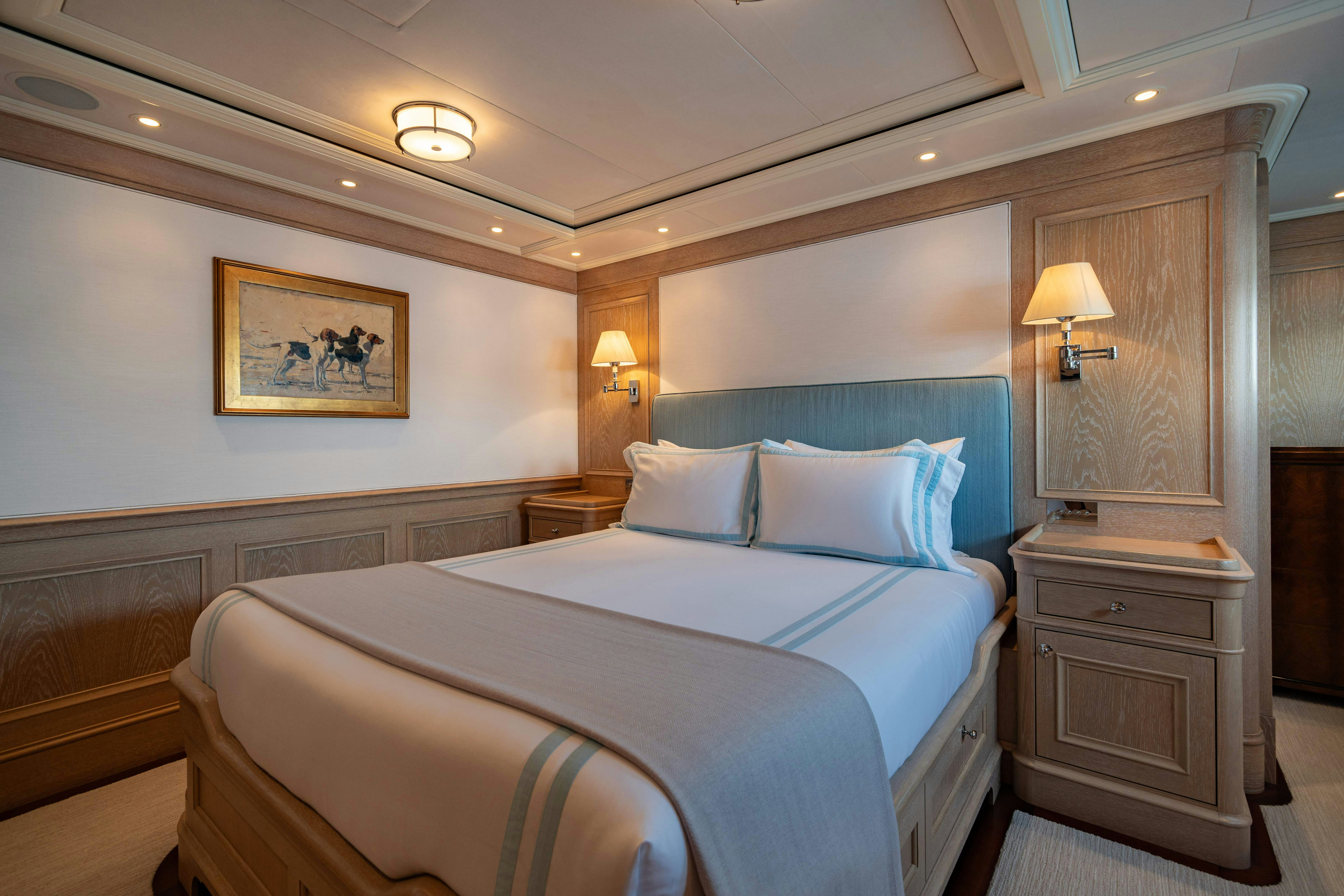 a bed with a blue pillow aboard FABULOUS CHARACTER Yacht for Charter