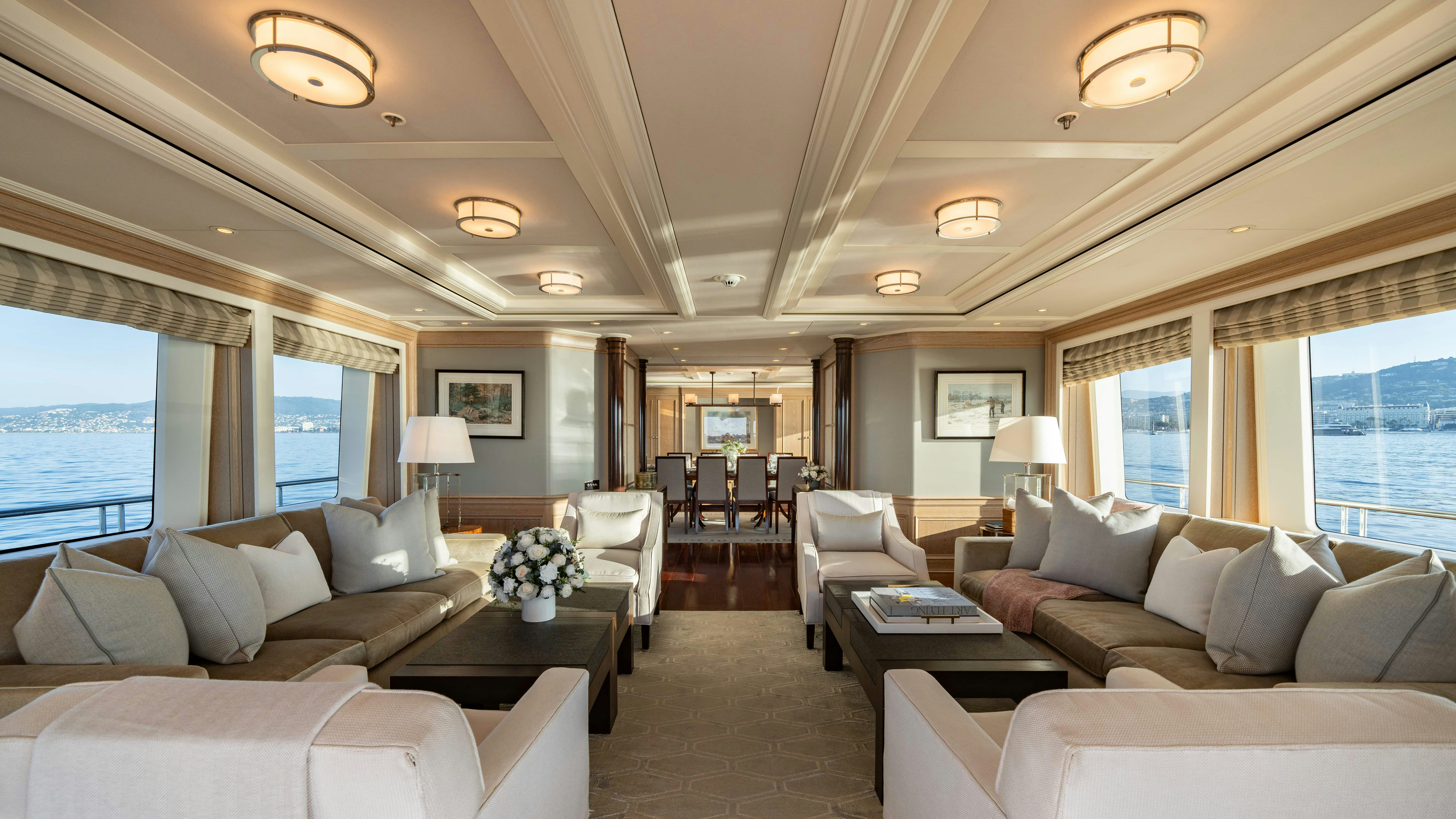 a living room with a large window aboard FABULOUS CHARACTER Yacht for Charter
