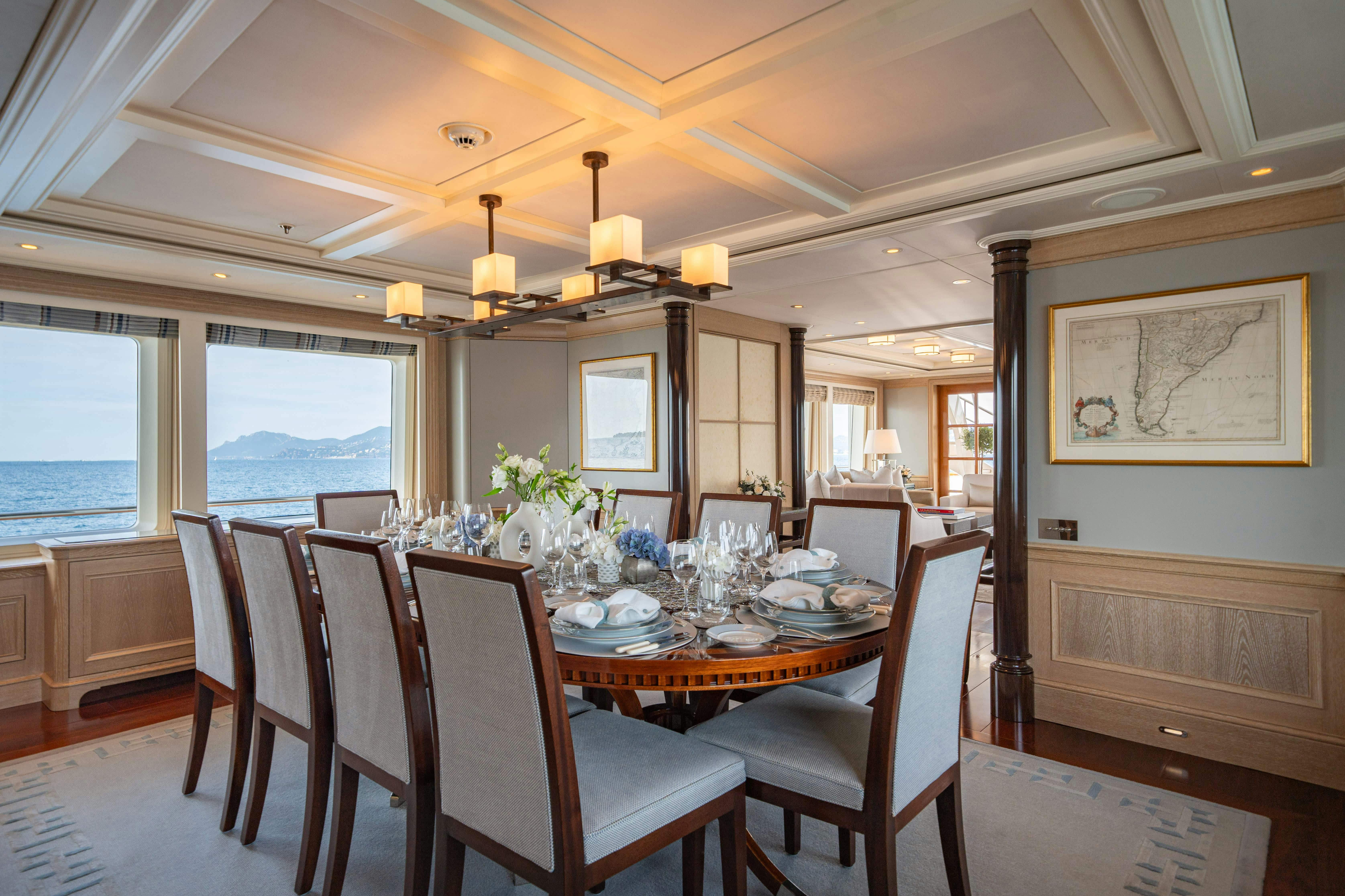 a dining room with a table and chairs aboard FABULOUS CHARACTER Yacht for Charter