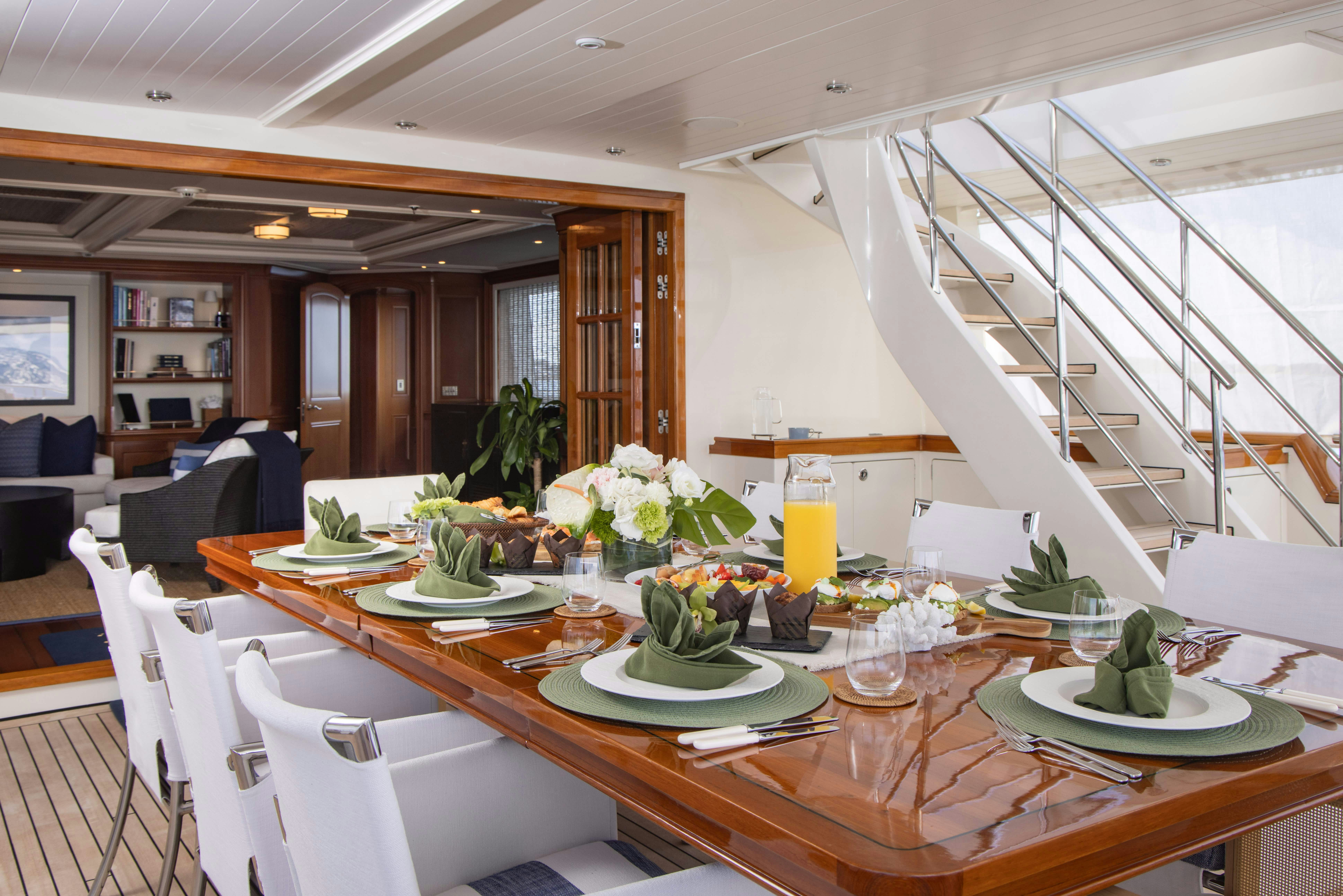 a dining room with a staircase aboard FABULOUS CHARACTER Yacht for Charter