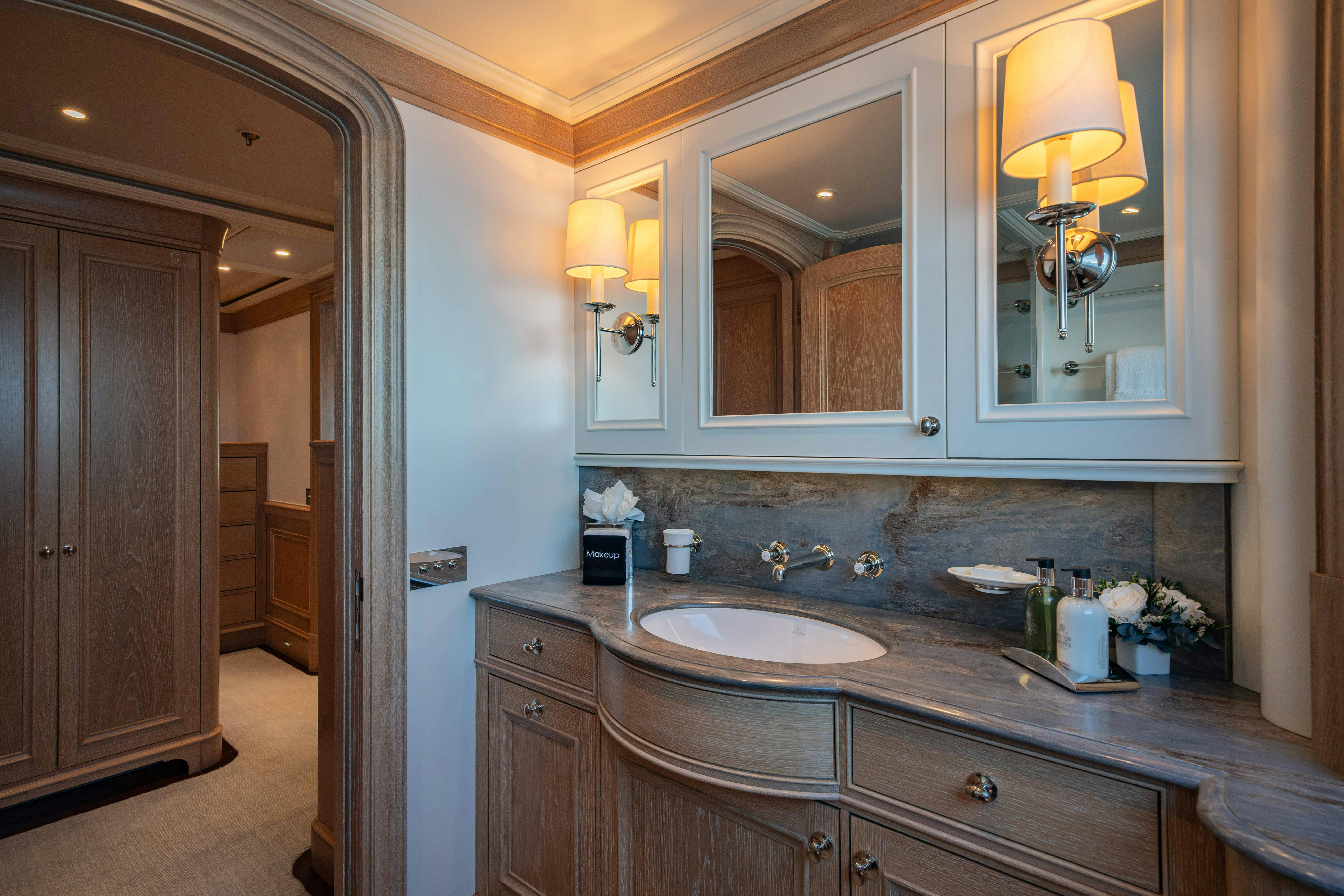 a bathroom with a large mirror aboard FABULOUS CHARACTER Yacht for Charter