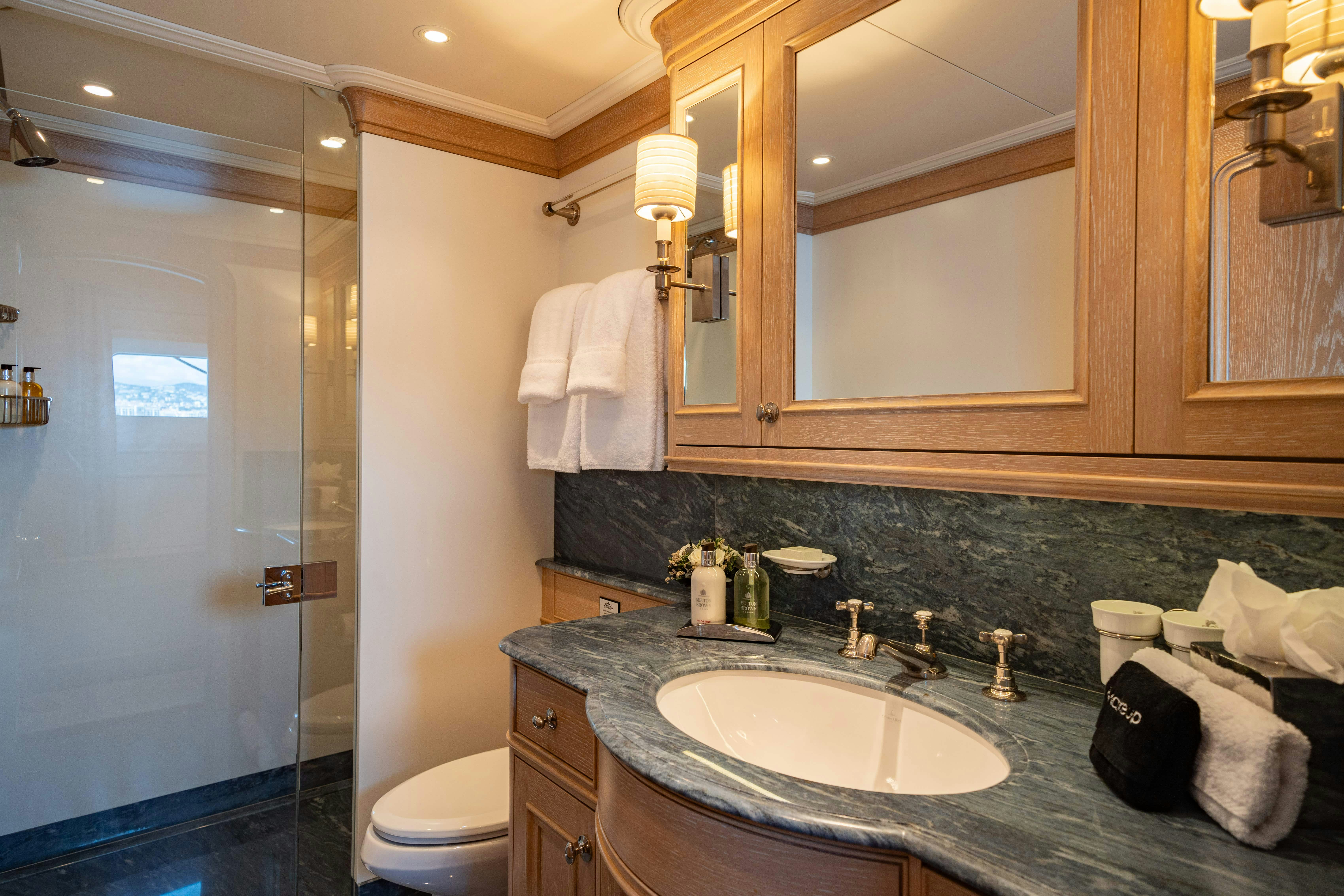 a bathroom with a sink and a mirror aboard FABULOUS CHARACTER Yacht for Charter