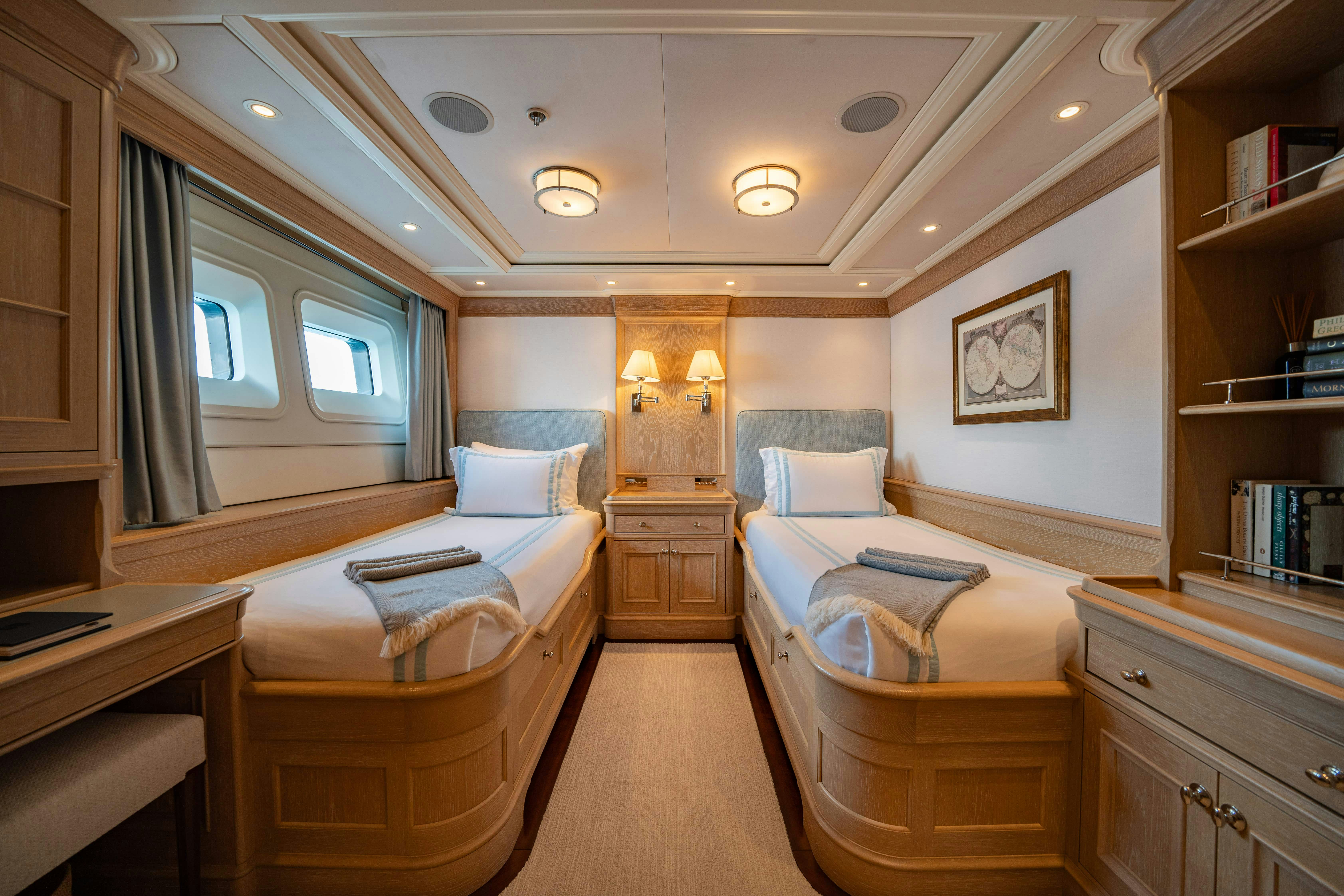 a bedroom with a bed and a desk aboard FABULOUS CHARACTER Yacht for Charter